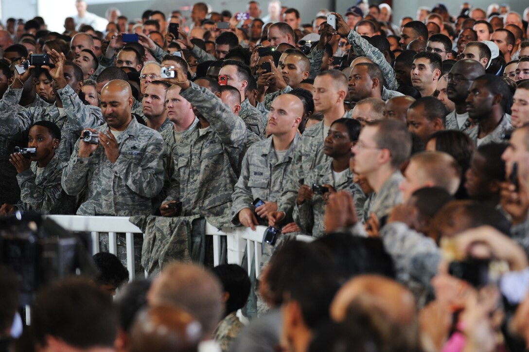 Servicemembers from Joint Base Langley-Eustis focus on First Lady Michelle Obama’s message during her speech at Langley Air Force Base, Va., Oct. 19, 2011. The first lady joined President Barack Obama at Langley stating, “America’s military and their families have inspired me not to just so sit back in awe, but to take action on their behalf.” (U.S. Air Force photo by Tech. Sgt. Christina M. Styer/Released)  