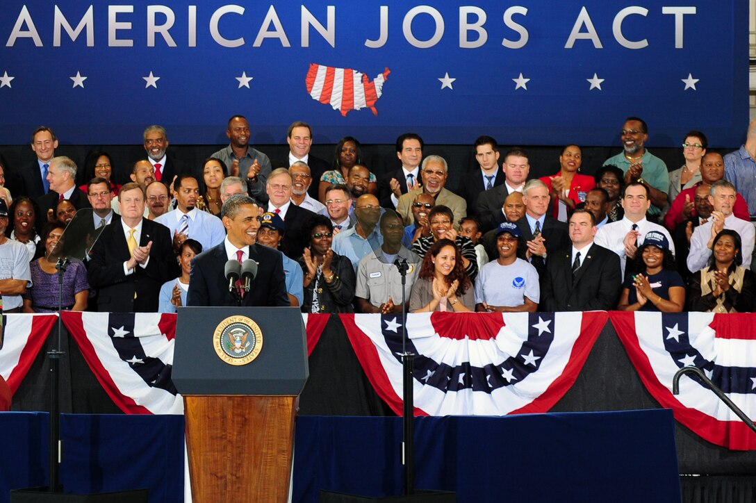 President Barack Obama takes the stage at Langley Air Force Base, Va., to speak about his American Jobs Act on Oct. 19, 2011.  The president’s comments focused on the abilities American veterans have to offer the civilian workforce.  (U.S. Air Force photo by Airman 1st Class Kayla Newman /Released)