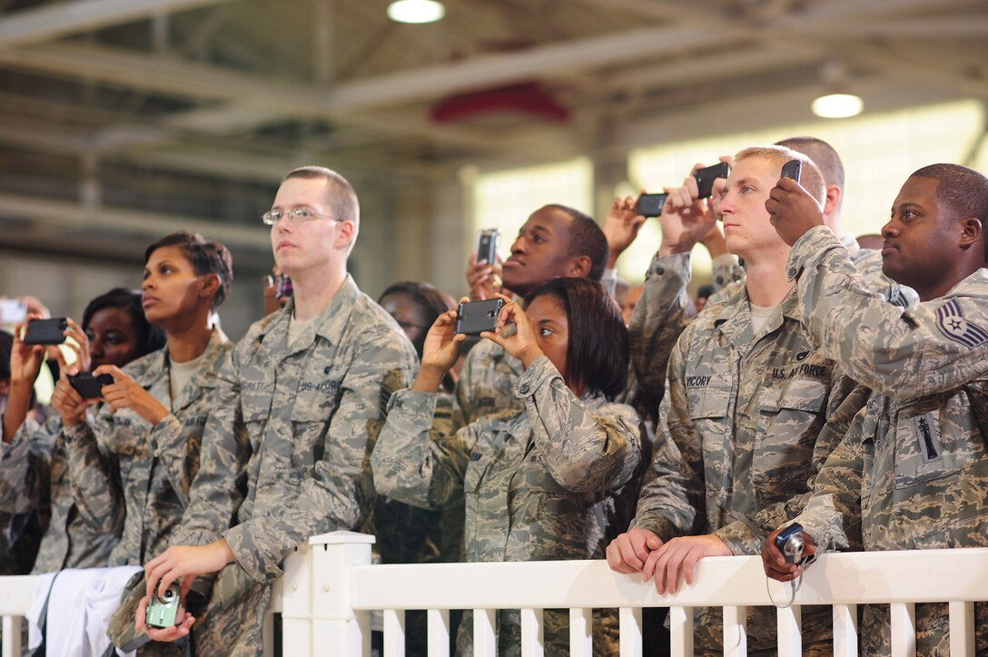 Airmen at Langley Air Force Base, Va., capture the moment during the presidential visit at the 94th Fighter Squadron hangar Oct. 19, 2011. President Obama spoke to the crowd about the importance of hiring America’s veterans.  (U.S. Air Force photo by Staff Sgt.Antoinette Gibson /Released)