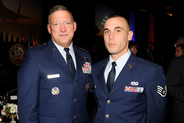 U.S. Air Force Gen. Gary L. North; Pacific Air Forces commander, U.S. Pacific Command Air Component commander and Pacific Air Combat Operations Staff executive director at Hickam Air Force Base, Hawaii; poses with U.S. Air Force Staff Sgt. Paul Palmer, 763rd Maintenance Squadron aircraft electrical and environmental systems journeyman, after Palmer received a $1000 National Logistics Officer Association scholarship award during a LOA conference banquet Oct. 13, 2011, in Fort Worth, Texas.  Palmer recently won the Las Vegas LOA blackjack chapter scholarship and competed with other award submissions from all logistics-related career fields Air Force-wide to win the national-level scholarship.  (Courtesy photo)