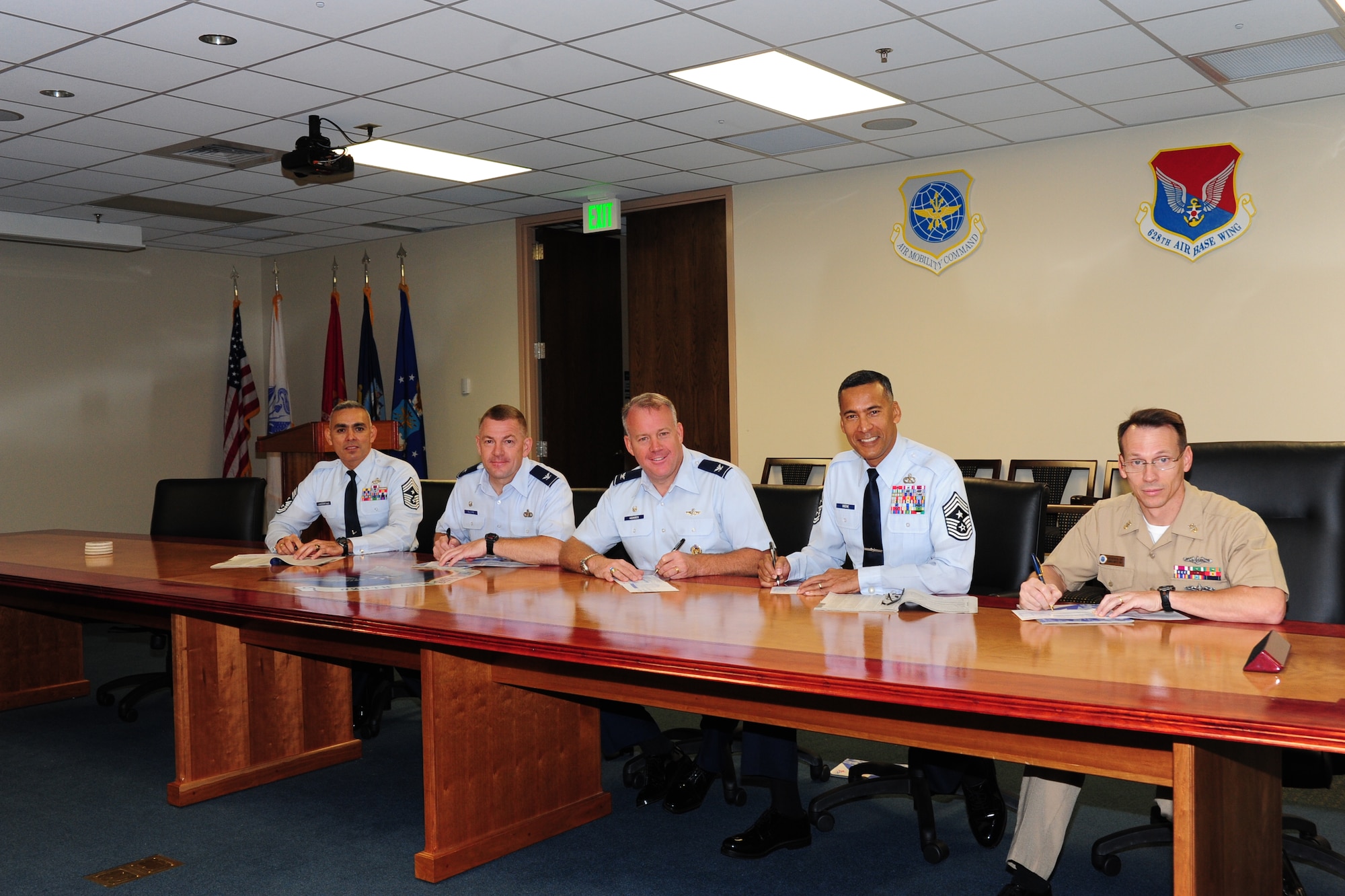 (From left to right) Chief Master Sgt. Jose LugoSantiago, Col. Richard McComb, Col. Erik Hansen, Chief Master Sgt. Terrence Greene and Master Chief Billy Cady sign their 2012 Combined Federal Campaign donations Oct. 18 at Joint Base Charleston. The CFC is currently underway for Team Charleston until Nov. 11 and is designed to give all federal employees an opportunity to donate to eligible non-profit organizations. LugoSantiago is the 628th Air Base Wing command chief, McComb is the Joint Base Charleston commander, Hansen is the 437th Airlift Wing commander, Greene is the 437th AW command chief and Cady is the JB Charleston-Weapons Station command master chief. (U.S. Air Force photo/Tech. Sgt. Chrissy Best) 