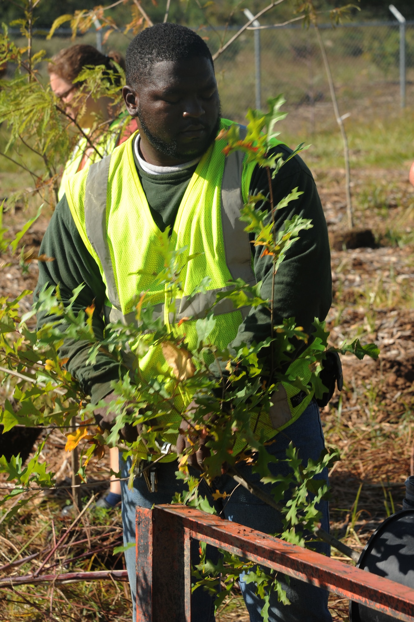 Brandon Nelson, a contract worker on the skeet range restoration project, prepares to plant a tree Oct. 13. The project began in September 2010, and made the area an ecologically safer place for base personnel and wildlife alike. More than 36 million pounds of contaminated soil, roughly 450 semi-trucks full, was excavated from the site for safety purposes. (U.S. Air Force photo by Airman 1st  Class Kaylee Clark)