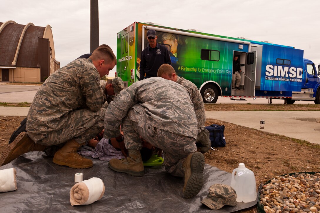Firefighters from the 28th Civil Engineer Squadron and medical personnel from the 28th Medical Operations Squadron, train on a Simulation in Motion-South Dakota Human Patient Simulator at Ellsworth Air Force Base, S.D. Oct. 14, 2011. The simulator talks, bleeds and cries, amongst other things, to provide emergency responders with state-of-the-art training so they can better respond to accidents and incidents. (U.S. Air Force photo by Tech. Sgt. Nathan Gallahan/Released)