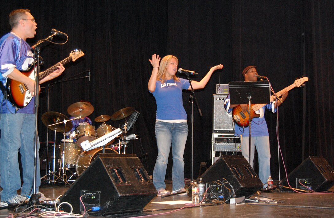 LAUGHLIN AIR FORCE BASE, Texas - Staff Sgt. Greg Lacy, lead guitar, Staff Sgt. Courtney Clifford, vocals, Staff Sgt. Ron Sadler, drums, and Senior Airman Henry Roberson, bass guitar, from the United States Air Force Band of the West perform a disco hit from the 1970s. They played variety music at the Paul Poag Theatre in Del Rio Oct.15. The free concert was open to the public as part of Fiesta de Amistad, a week-long event promoting friendship between the sister cities of Del Rio and Cuidad Acuna. (U.S. Air Force photo/Master Sgt. Peter Borys)
