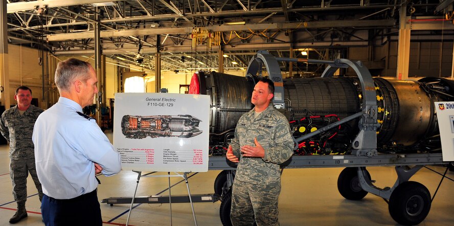 U.S. Air Force Tech. Sgt. Justin Lawson, 20th Component Maintenance Squadron assistant section chief, briefs Gen. Michael Hostage, Air Combat Command commander, with a breakdown of a F-110 jet engine and its capabilities Shaw Air Force Base, S.C. Oct. 18, 2011.  The General Electric F-110 jet engine is a major part of Shaw's F-16 Fighting Falcons and is capable of about 30,000 pounds of thrust.  (U.S. Air Force photo/Airman 1st Class Neil D. Warner)