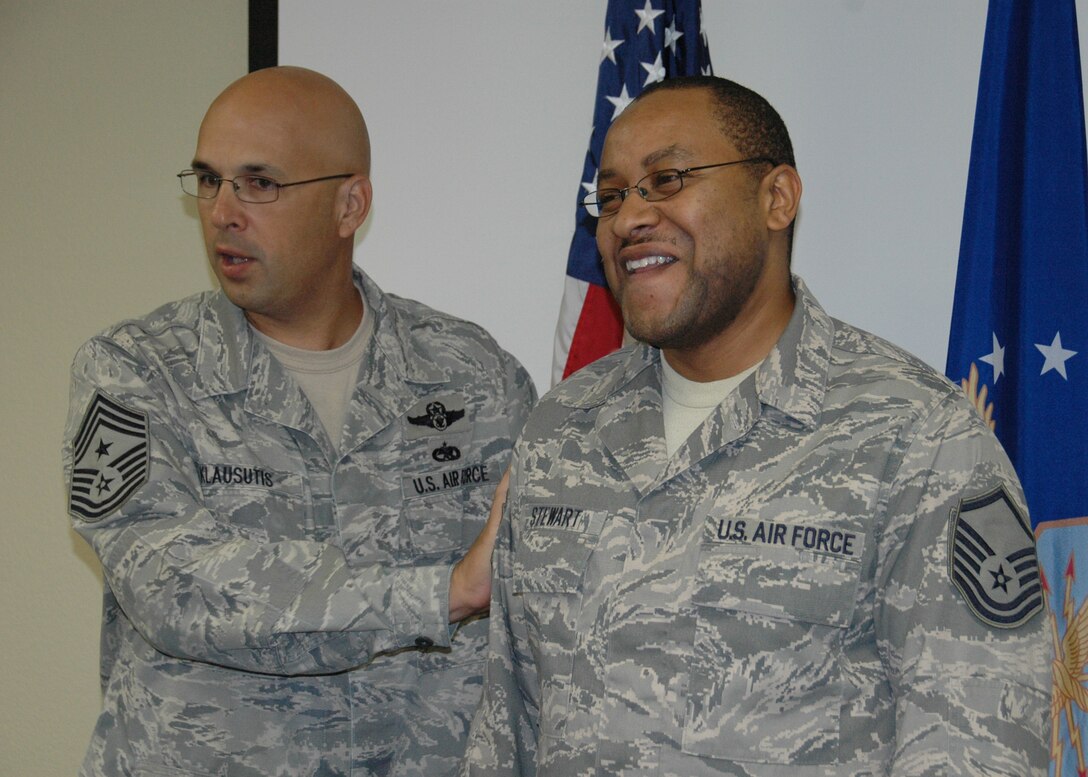 Master Sgt. Narvin Stewart of the 919th Communications Squadron smiles as Chief Master Sgt. Michael Klausutis, the 919th Special Operations Wing Command Chief, tacks on his new enlisted stripes Oct. 1 at Duke Field, Fla.  Stewart was one of six Duke Field reservists promoted under the Air Force Reserve’s Promotion Enhancement Program, designed to recognize exceptional performers for promotion to the grades of technical sergeant through chief master sergeant.  Two of the PEP promotees, Senior Master Sgt. Bruce Tims of the 919th Operations Support Squadron and Tech. Sgt. Nina Stubbs of the 5th Special Operations Squadron, were away on temporary duty assignments and unavailable for photos as the wing’s senior leaders traveled about the base to conduct the surprise promotion events.  (U.S. Air Force photo/Dan Neely)