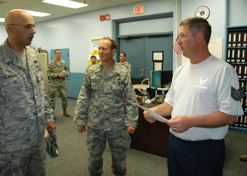 Chief Master Sgt. Michael Klausutis, the 919th Special Operations Wing Command Chief, left, congratulates newly promoted Tech. Sgt. Berry Drake of the 919th Maintenance Squadron as he holds his official promotion order Oct. 1 at Duke Field, Fla.   Drake was one of six Duke Field reservists promoted under the Air Force Reserve’s Promotion Enhancement Program, designed to recognize exceptional performers for promotion to the grades of technical sergeant through chief master sergeant.  Two of the PEP promotees, Senior Master Sgt. Bruce Tims of the 919th Operations Support Squadron and Tech. Sgt. Nina Stubbs of the 5th Special Operations Squadron, were away on temporary duty assignments and unavailable for photos as the wing’s senior leaders traveled about the base to conduct the surprise  promotion events.  (U.S. Air Force photo/Dan Neely)
