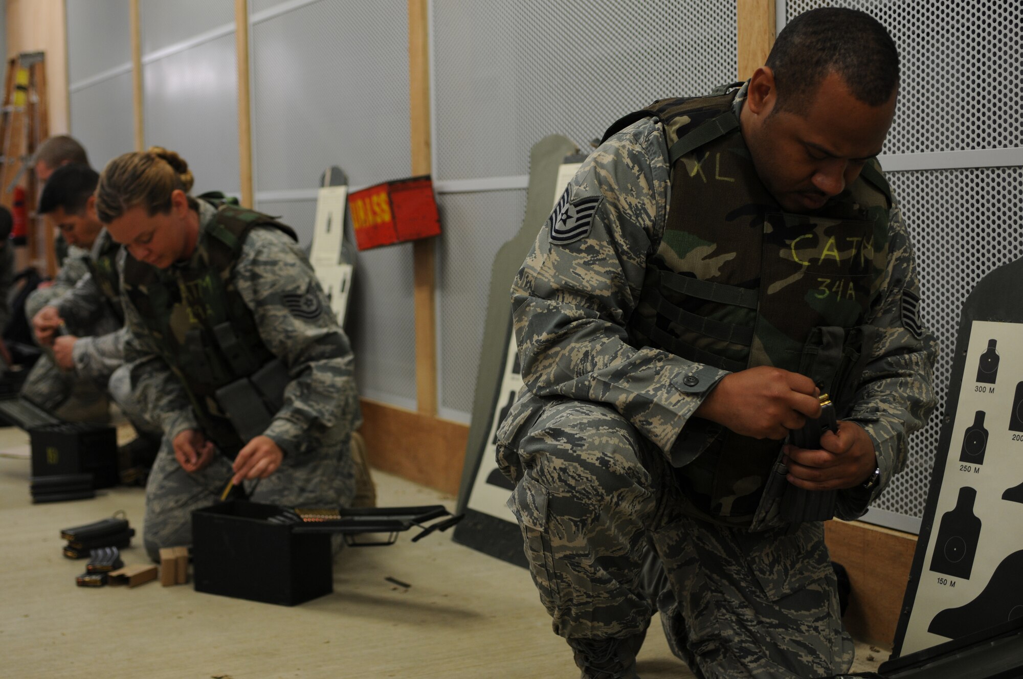 U.S. Air Force Airmen from RAF Lakenheath load ammunition into magazines for rifle qualifications for deployment readiness at RAF Feltwell, England, on April 29, 2011. The 48th Fighter Wing provides all-weather, day or night air superiority and air-to-ground precision combat capability as well as combat search and rescue capabilities. (U.S. Air Force photo by Airman Cory D. Payne/Released)