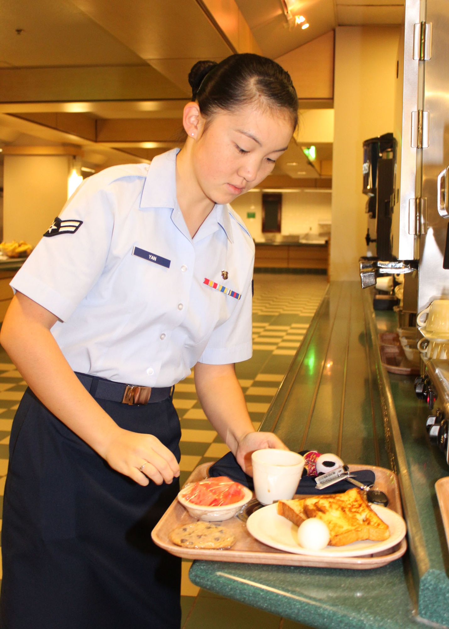 Airman 1st Class Shujie Yan, Medical Technician, 95th Medical Operations Squadron, is one of the first Airmen to enjoy the newly reopened dining facility at Edwards AFB Oct. 17. (U.S. Air Force Photo by Meredith Mingledorff) 