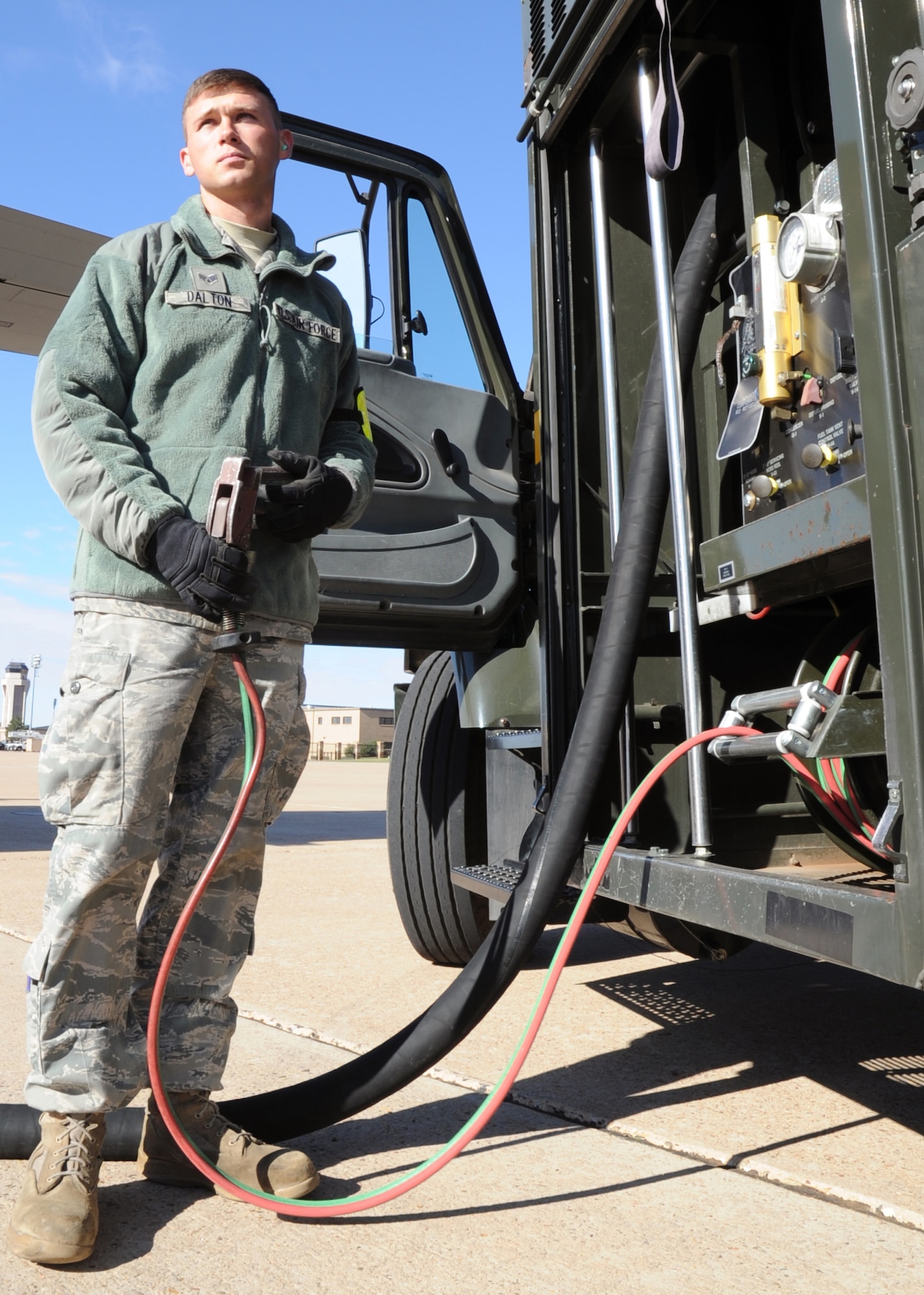U.S. Air Force Senior Airman Tanner Dalton, 27th Special Operations Logistics Readiness Squadron fuels apprentice, grips a hose, also called a “dead man” hose, used to initiate and halt refueling of aircraft on the flightline at Cannon Air Force Base, N.M., Oct. 18, 2011. The refueling process varies in time depending on the load capacity of the aircraft in need of service.  (U.S. Air Force photo by Airman 1st Class Alexxis Pons Abascal)