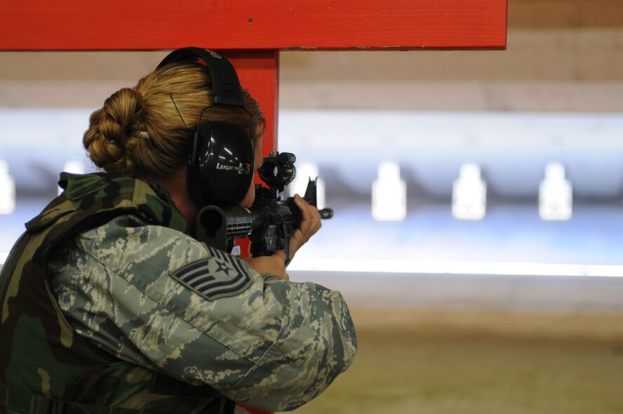 RAF FELTWELL, England - U.S. Air Force Tech. Sgt. Amanda St. Laurent, 56th Rescue Squadron independent duty mechanical technician, fires a M4 rifle during qualifications for deployment readiness at RAF Feltwell, England, on April 29, 2011. RAF Mildenhall Airmen will begin the new course once it is implemented Dec. 1, 2011. (U.S. Air Force photo by Airman Cory D. Payne/Released)