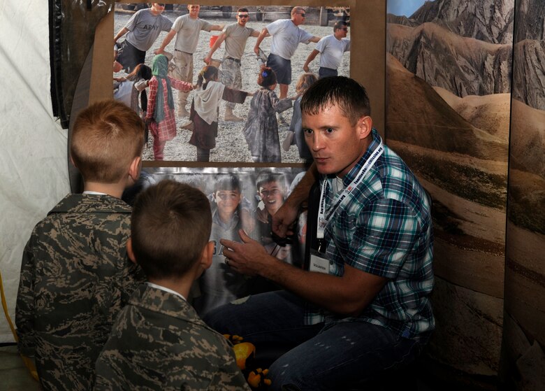 Tech. Sgt. Travis Hughes, Airman and Family Readiness Center noncommissioned officer-in-charge of readiness, teaches children about Afghanistan terrain and overall deployment life during Camp Desert Kids at Mountain Home Air Force Base, Idaho, Oct. 15, 2011. The program, which is sponsored by Military Families United, has helped more than 1,000 children better understand the locations where their parents deploy to. (U.S. Air Force photo by Senior Airman Angelina Drake)