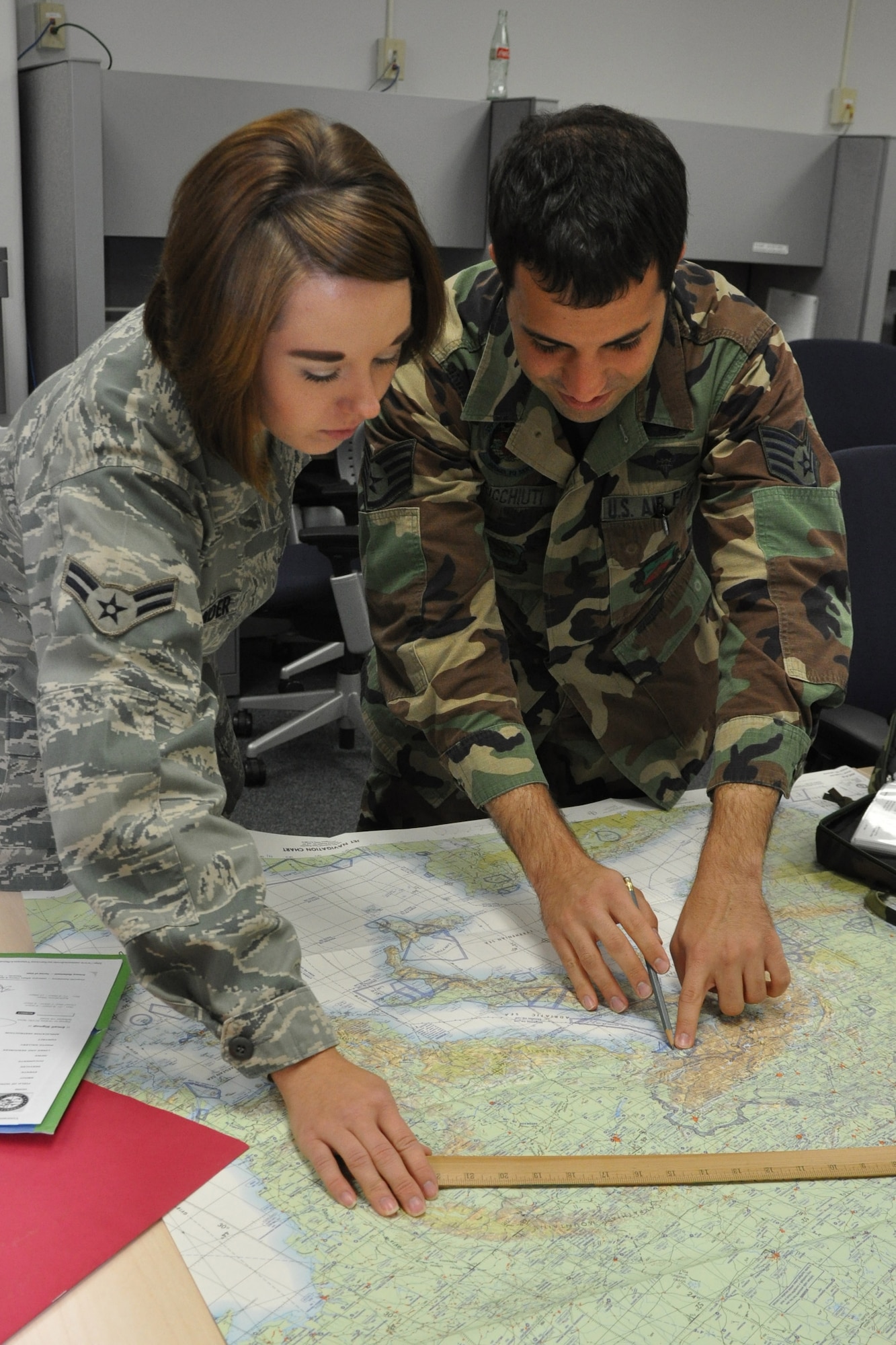 YOUNGSTOWN AIR RESERVE STATION, Ohio -- Air Force Reserve  Airman First Class Susan Ostrander and Staff Sgt. Peter Ricchiuti, both Operations Intelligence Specialists, plot and extracting geographic coordinates on a map as part of their proficiency training. The two airmen are part of a flight of more than 20 intelligence specialists serving the 910th Airlift Wing. U.S. Air Force photo by Maj. Brent J. Davis