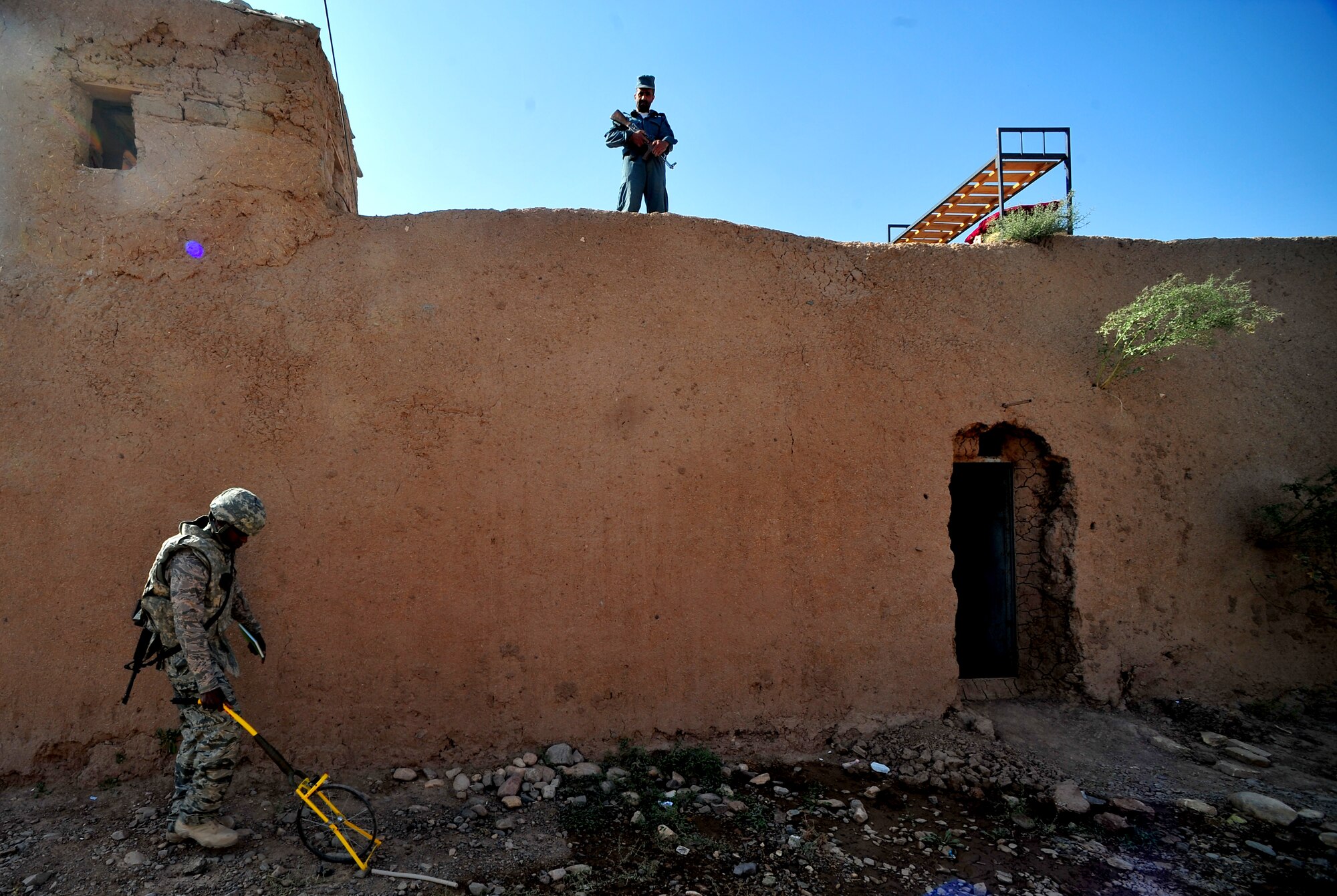 Staff Sgt. Chananyah Stuart takes measurements to begin installing a new dining facility and multiple latrines at the Afghan National Police Headquarters in Herat City, Oct. 15, 2011. Stuart, an RSC-West civil engineer, is slated to begin training to become a military training instructor following his deployment. He is currently deployed from Luke AFB, Ariz. (U.S. Air Force Photo/SrA Tyler Placie)