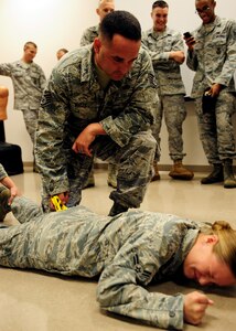 Airman 1st Class Heather Ives reacts to being tased by Staff Sgt. Neil White after volunteering to be tased at Joint Base Charleston Oct. 18. The taser is a preventive measure and often prevents unnecessary loss of life. Both White, a Security Forces Trainer and  Ives, a Security Forces Apprentice, are with the 628th Security Forces Squadron. (U.S. Air Force photo/Staff Sgt. Katie Gieratz)