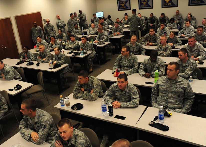 Staff Sgt. Neil White distributes tasers to a class of 628th Security Forces members during taser training at Joint Base Charleston Oct. 18. The 628th SFS members also reviewed Use of Force training during the class as part of their annual training requirements. White is a trainer with the 628th SFS. (U.S. Air Force photo/Staff Sgt. Katie Gieratz)