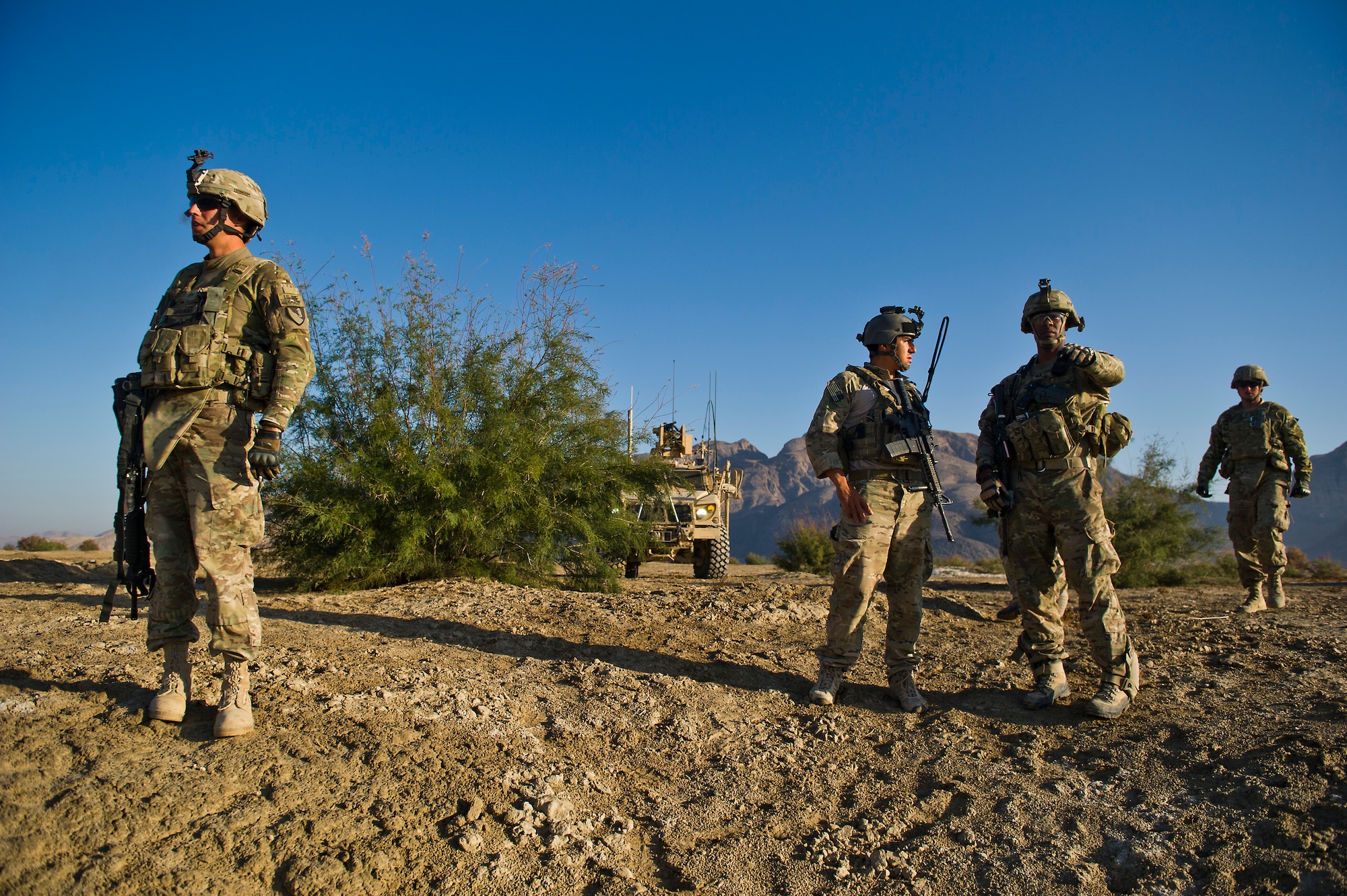 U.S. Air Force Joint Terminal Attack Controller, Senior Airman Cristobal Galindo, 807th Expeditionary Air Support Squadron, and native of San Bernardino, Calif., talks to Capt. Brandon Mott, commander, U.S. Army Alpha Troop, 2nd Squad, 38th Calvary, Ft. Hood, Texas, during an operations near Spin Boldak, Afghanistan on Oct. 13, 2011. Mott and Galindo are coordinating plans for use of combat air support during a mission designed to clear an area suspected of housing insurgents.  (U.S. Air Force Photo/Master Sgt. Jeffrey Allen)