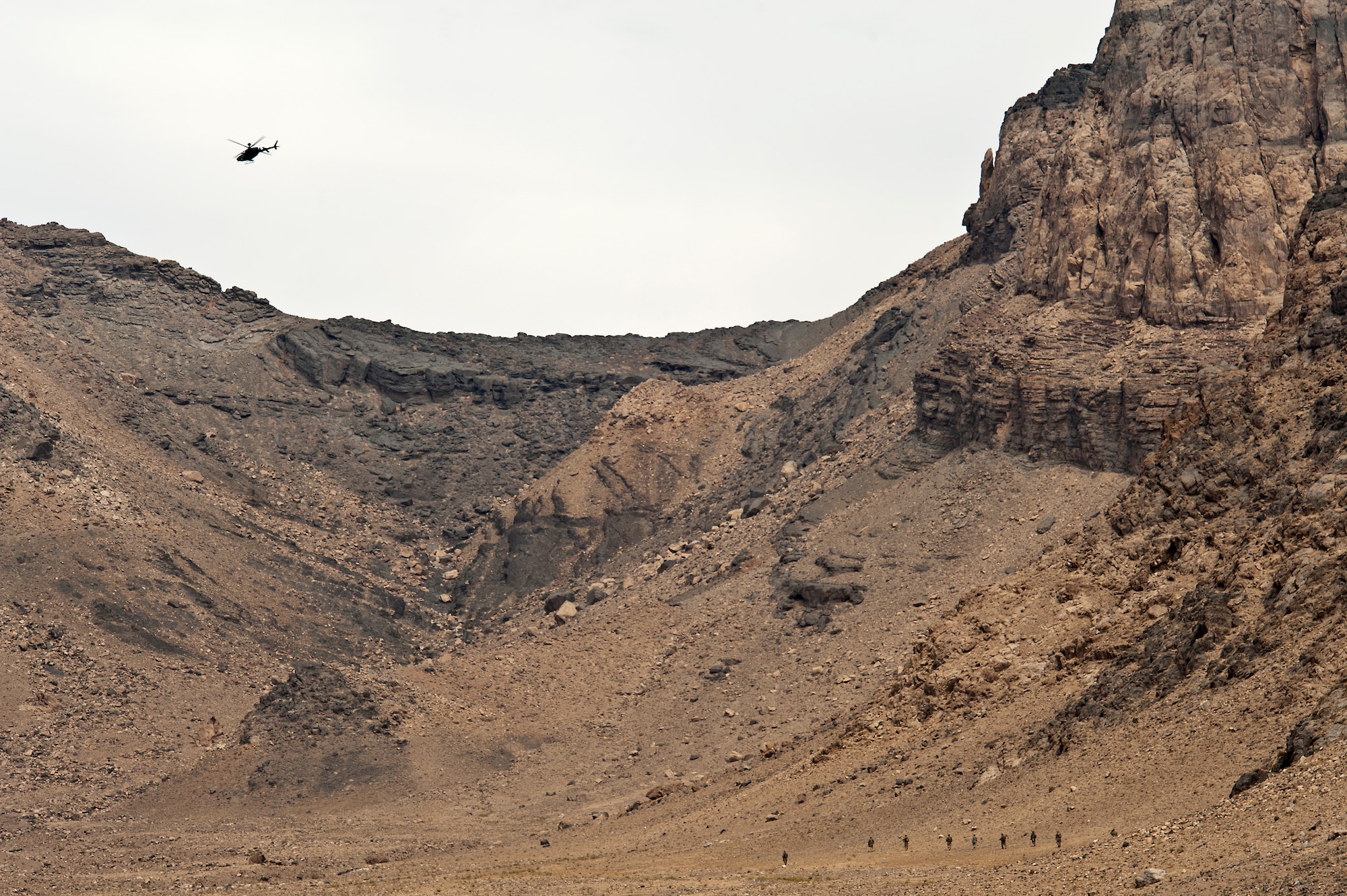 A U.S. Army OH-58 Kiowa crew provides air cover for members of the U.S. Army 2nd Squad, 38th Calvary, Ft. Hood, Texas, as they conduct a foot patrol to clear a draw in the mountains near Spin Boldak, Afghanistan, on Oct. 12, 2011. The OH-58 coordinates air support with U.S. Air Force Joint Terminal Attack Controller, Senior Airman Cristobal Galindo, 807th Expeditionary Air Support Squadron, who controls all air assets support patrol. (U.S. Air Force Photo/Master Sgt. Jeffrey Allen)