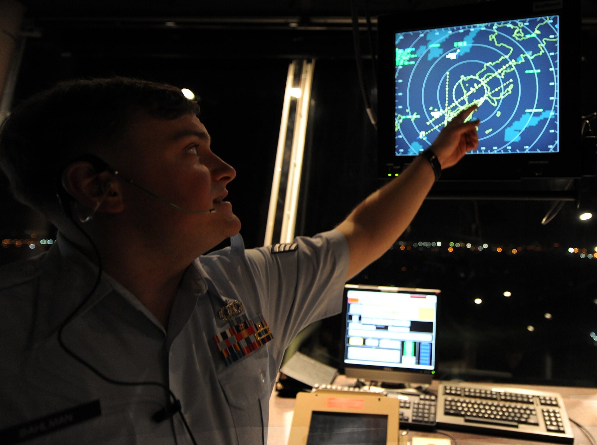 U.S. Air Force Staff Sgt. Christopher Bahlman, 18th Operations Support Squadron air traffic controller, points at a standard approach radar system on Kadena Air Base, Japan, Oct. 17. A standard approach radar system is a video live feed which shows the correlation between aircraft and the airfield. (U.S. Air Force photo/Airman 1st Class Jarvie Z. Wallace/released)