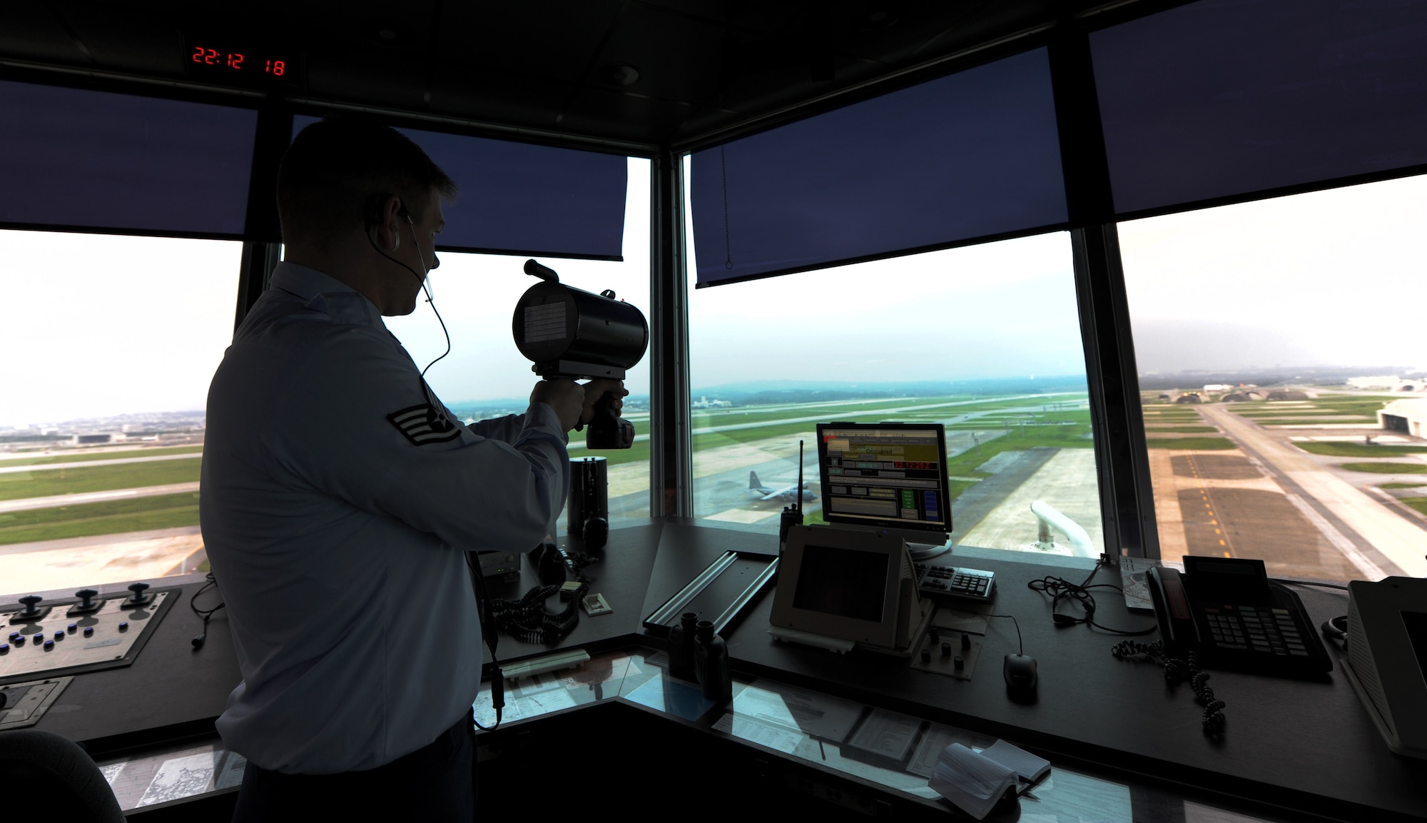 U.S. Air Force Staff Sgt. Liam Taylor, 18th Operations Support Squadron air traffic controller, gives a light signal on Kadena Air Base, Japan, Oct. 17. A light gun signal is a backup communication method for vehicles and aircraft airborne or on the ground. (U.S. Air Force photo/Airman 1st Class Jarvie Z. Wallace)
