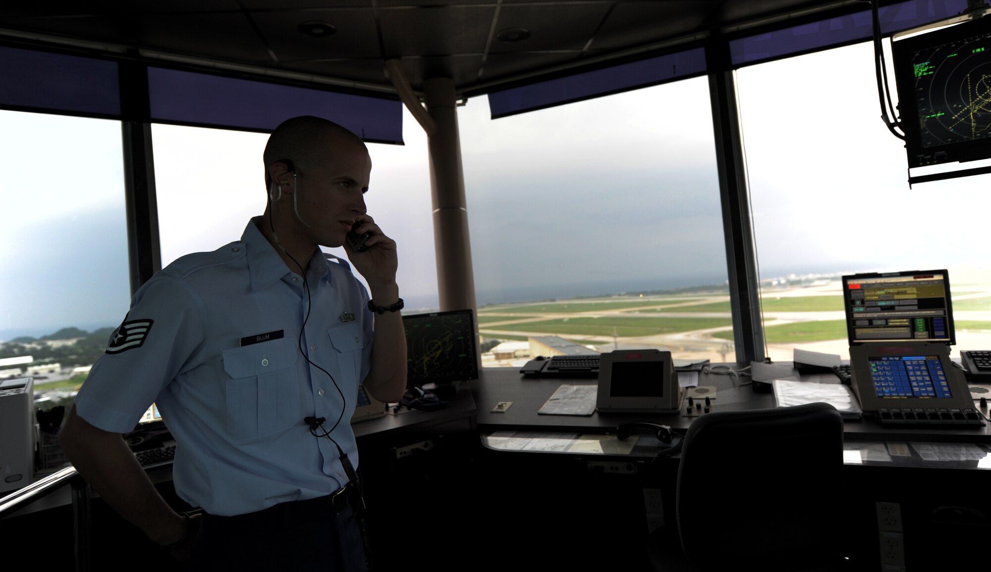 U.S. Air Force Staff Sgt. Nicholas Blum, 18th Operations Support Squadron air traffic controller, responds to a phone call on Kadena Air Base, Japan, Oct. 17. Air traffic controllers go through extensive training so they can help flight missions run smoothly and efficiently. (U.S. Air Force photo/Airman 1st Class Jarvie Z. Wallace)
