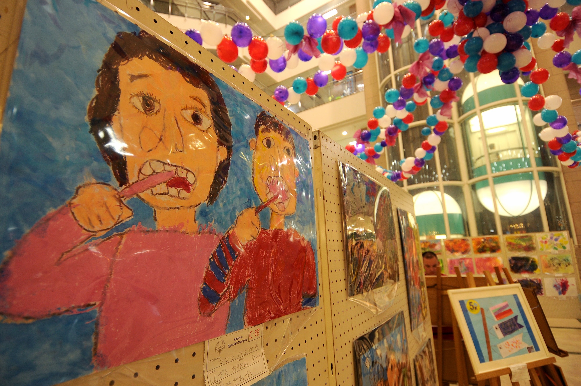 Some of the many Kadena Special Olympic paintings on display at Main City Shopping Mall San-A in Uruma City. Kadena Air Base's senior leadership helped open up the exhibit to raise awareness of the 12th Annual Kadena Special Olympics scheduled Nov. 5. Last year KSO rallied more than 1,500 athletes and 2,500 volunteers island-wide. (U.S. Air Force/Tech. Sgt. Jason Lake)