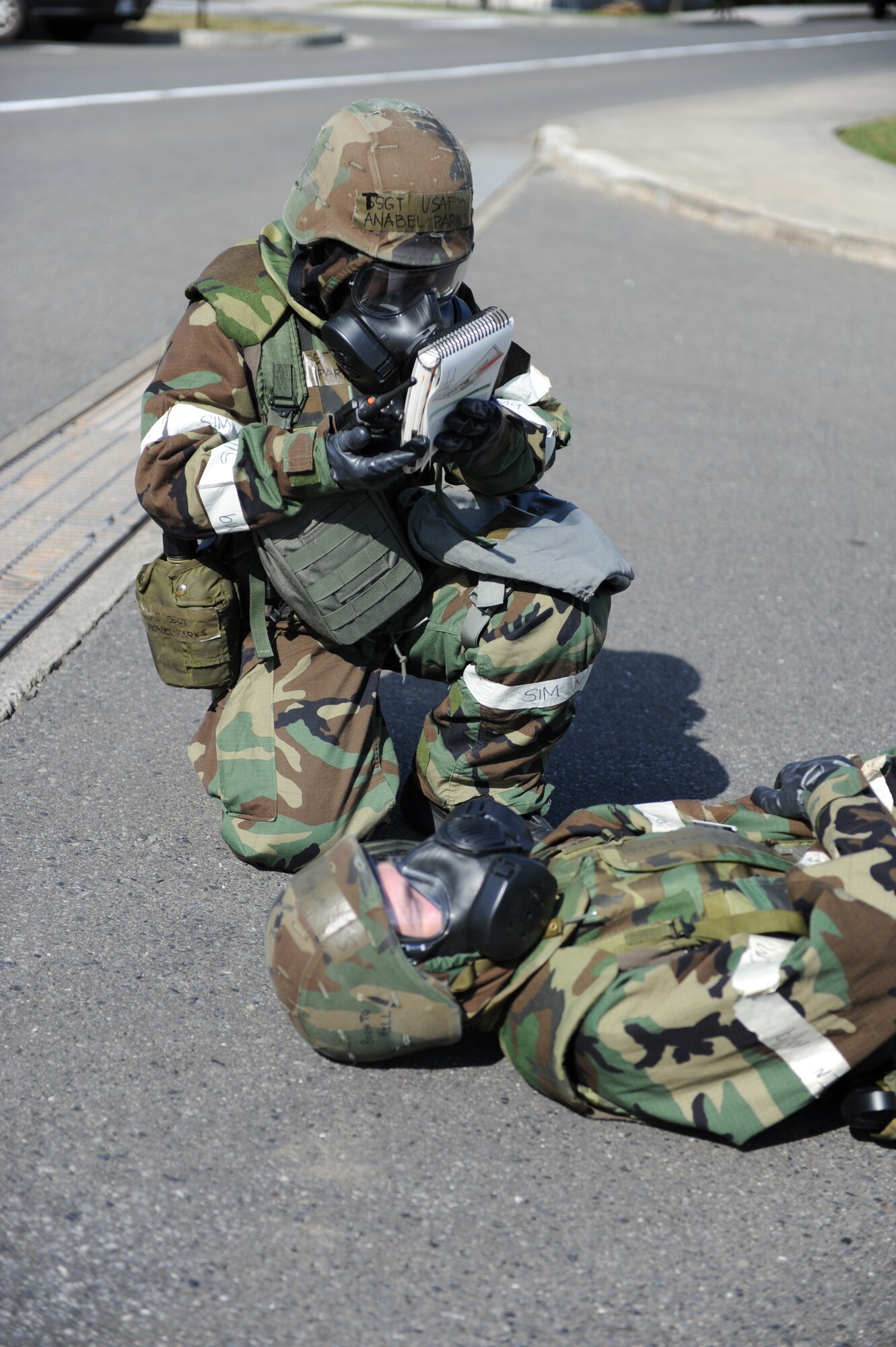 MISAWA AIR BASE, Japan -- Tech. Sgt. Anabel Parks, 35th Dental Squadron, references her Airman's Manual to make sure she follows correct procedures during an operational readiness exercise here Oct. 18. Readiness exercises ensure military personnel are capable of following appropriate protocol during real-world combat situations. (U.S. Air Force photo by Airman 1st Class Kia Atkins)