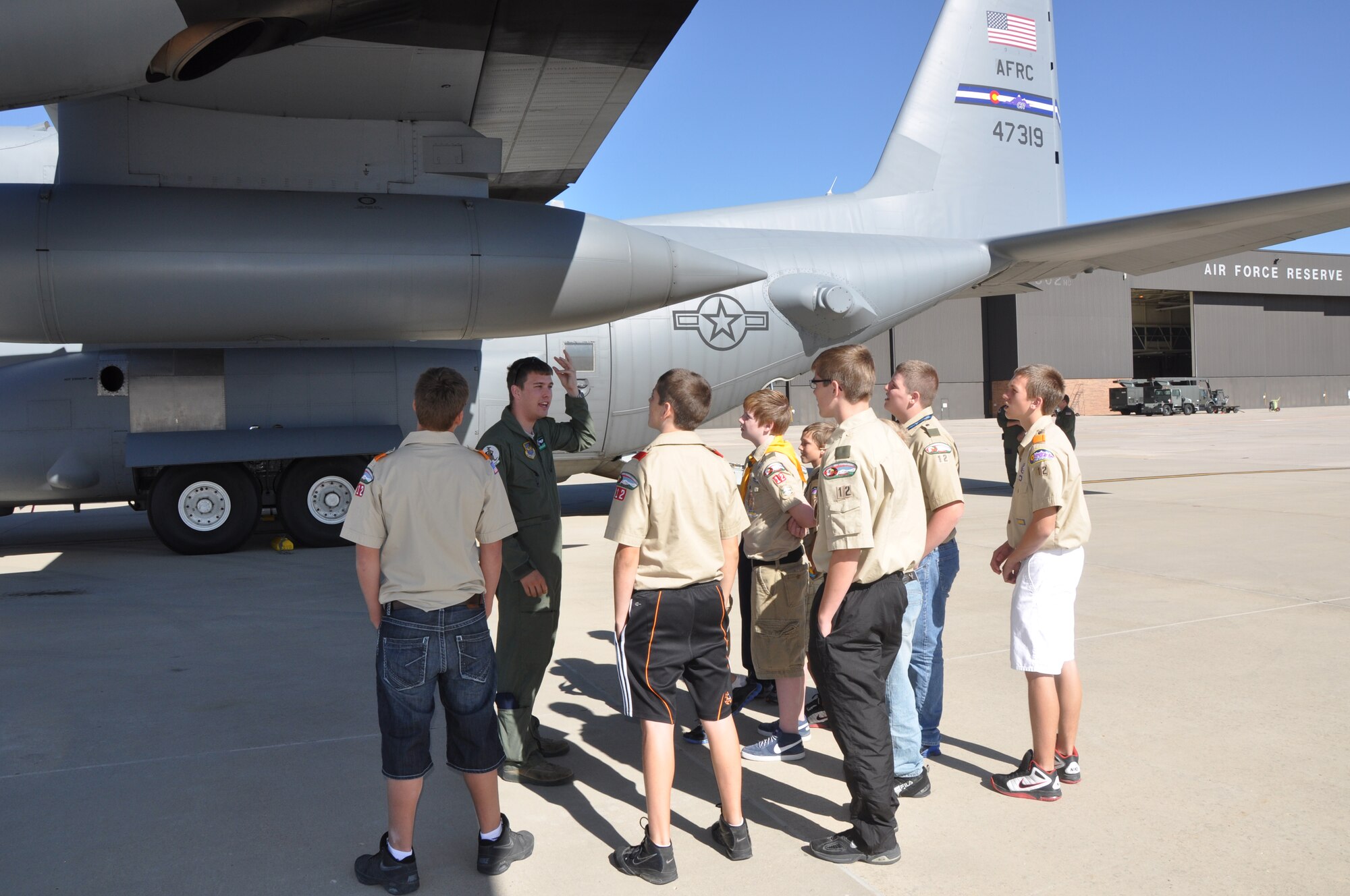 The Air Force Command Reserve's 302nd Airlift Wing, Peterson AFB Colo., hosted members of Boy Scout Troop 12 from Pueblo County for an afternoon tour of a C-130. Airman 1st Class Tristian Lyons a loadmaster with the 52nd Airlift Squadron explains to the scouts that the "bomb" like pods on the wings are actually fuel tanks. (U.S. Air Force photo/Tech. Sgt. Peter Dean)