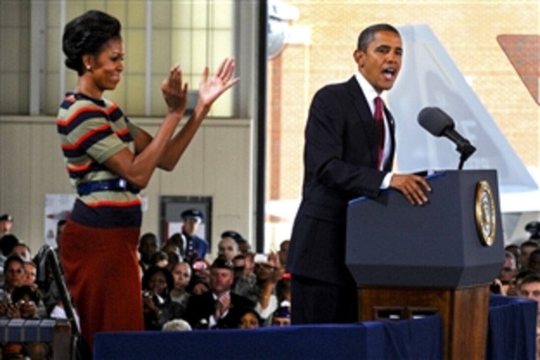 First Lady Michelle Obama applauds as President Barack Obama highlights the efforts and accomplishments of the men and women assigned to Joint Base Langley-Eustis during their official visit to Langley Air Force Base, Va., Oct. 19, 2011. The couple also expressed support for service members, veterans and military families.