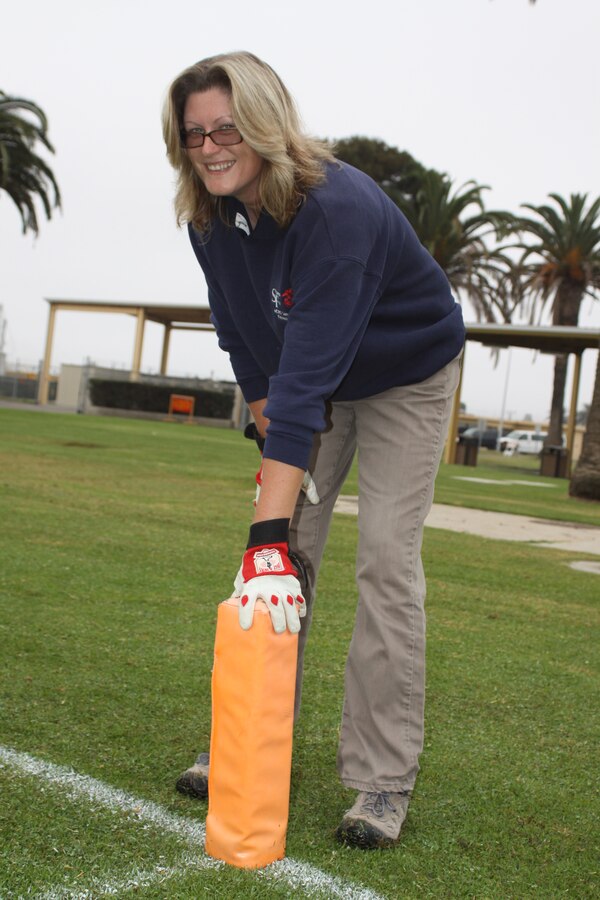 Rachel Dickinson, Marine Corps Community Services, intramural sports coordinator,sets up the football field before Powder Puff game Oct. 19 on Marine Corps Recruit Depot San Diego. For the past 12 years she has been orginizing everything from leagues to one-day tournaments for Department of Defense personnel aboard the depot. Dickinson is known for going the extra mile and putting others first. "Her focus is the military on the depot. She makes the program, giving one hundred and twenty percent," said Renaud Villedieu, intramural sports superviisor, who has been here boss all 12 years and is the one that hired her.
