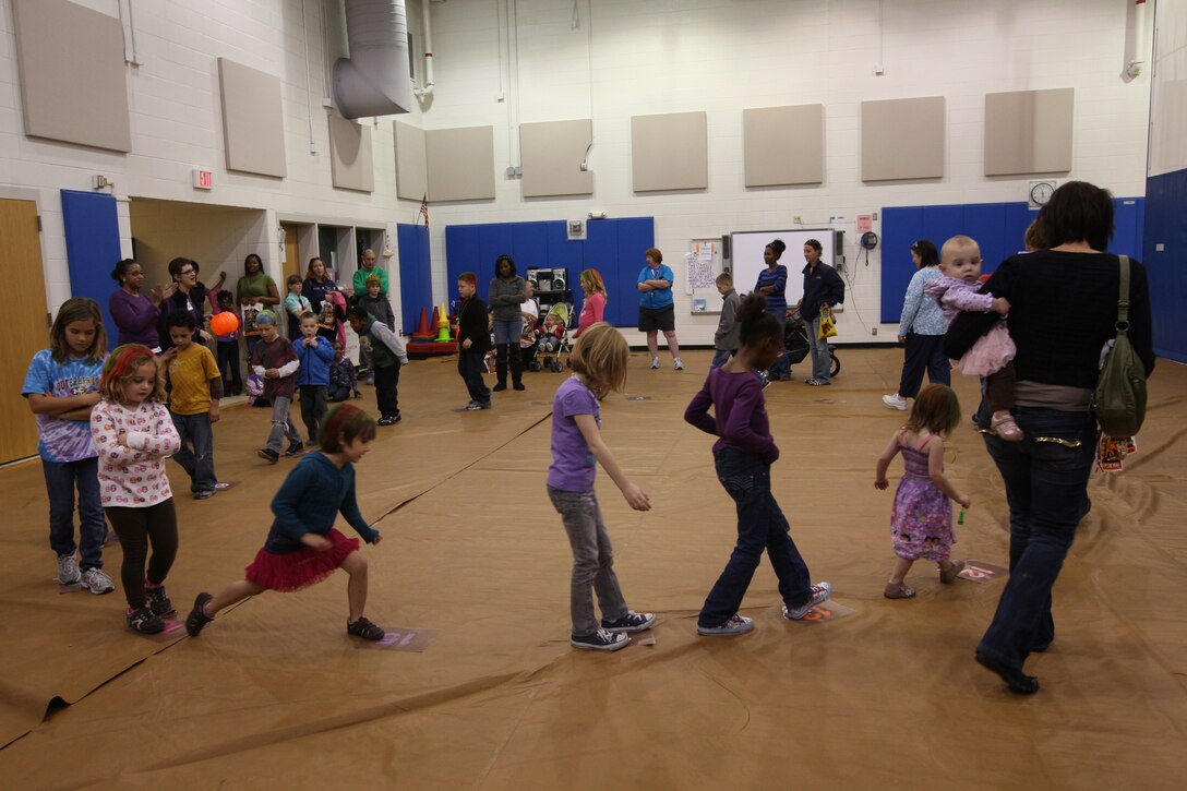 Children participate in the cake walk in a gymnasium during Johnson Primary School’s annual Fall Festival aboard Marine Corps Base Camp Lejeune, Oct. 20. Children painted their faces, played games and won prizes.