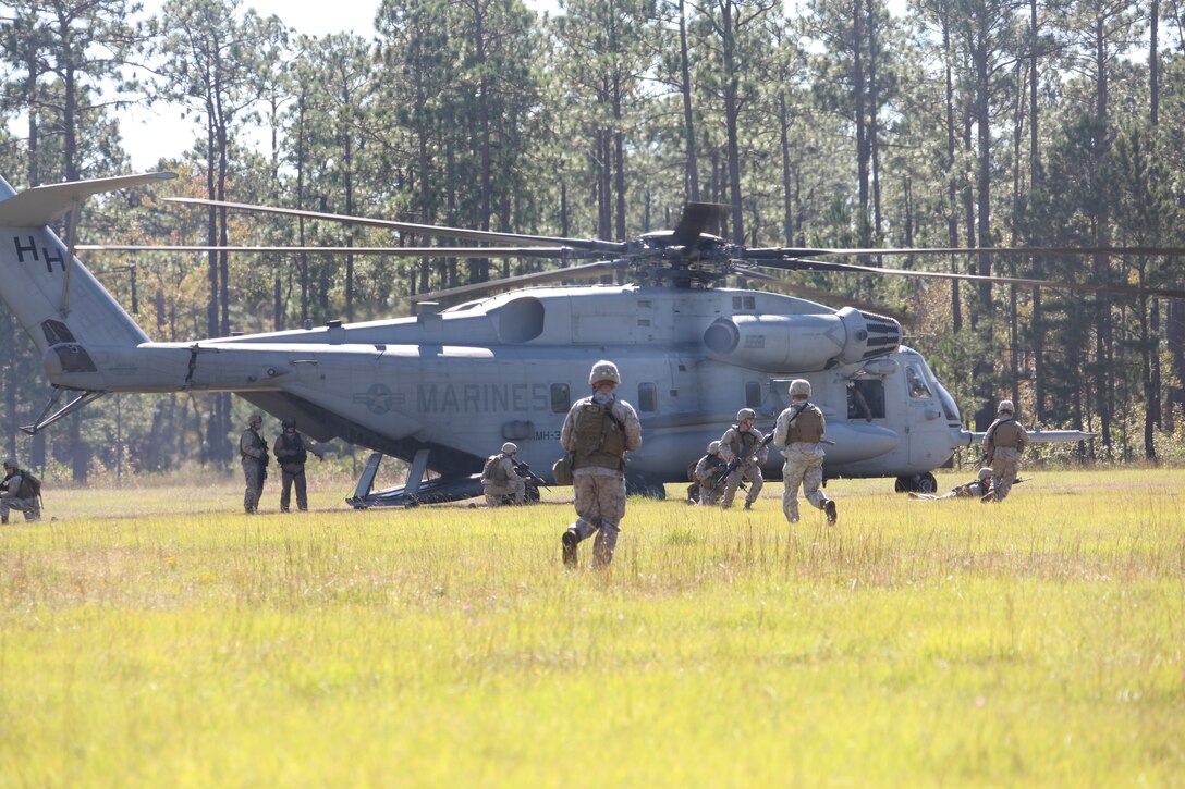 Marines from Company F exit and provide security for a simulated casualty evacuation on a HMH-366 CH-53E Super Stallion at Marine Corps Base Camp Lejeune Oct. 20.