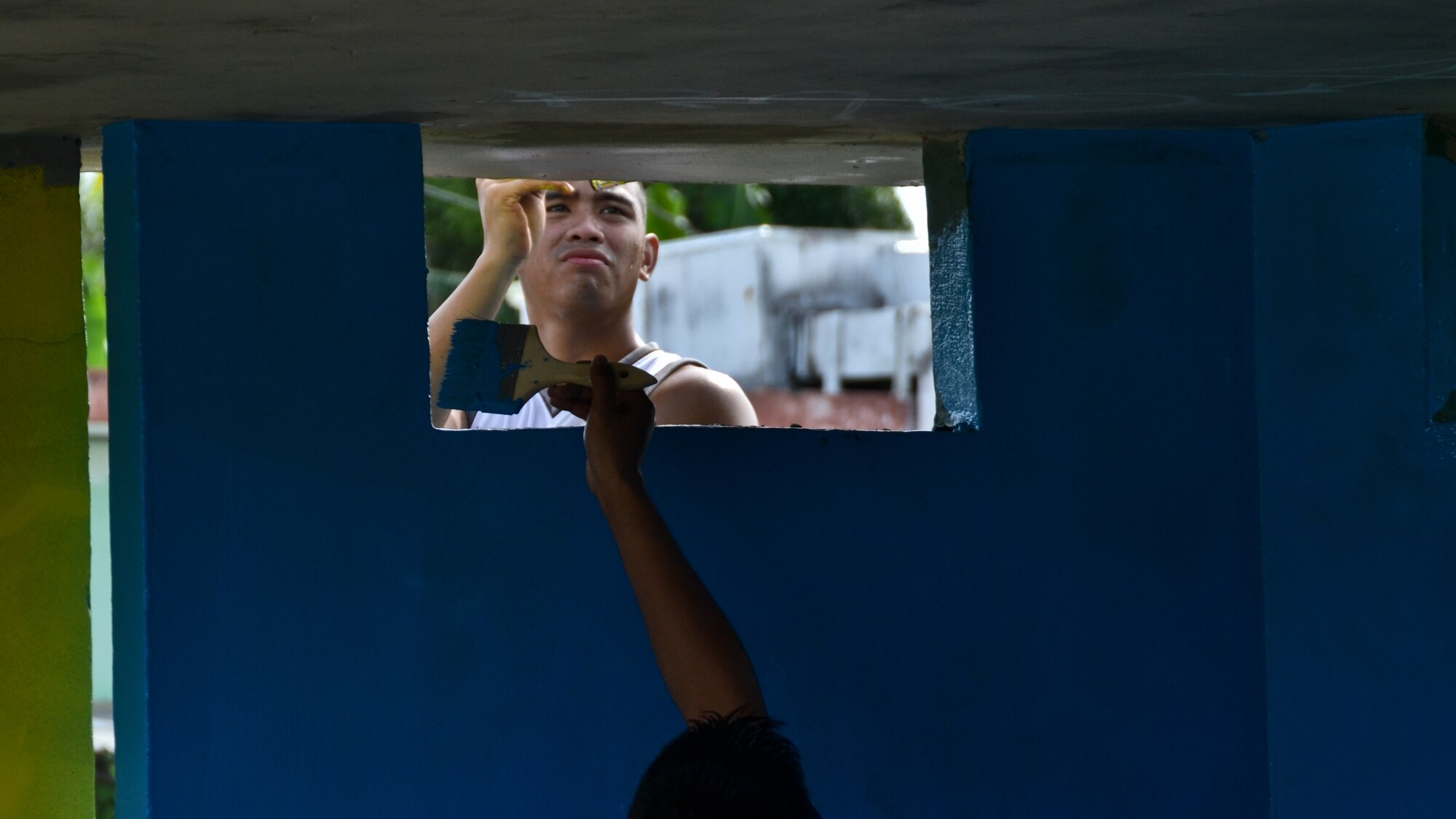 Airmen from the 36th Maintenance Squadron and 36th Wing chapel paint a bus stop for an Island Beautification project in Mangilao, Guam Oct 15.  Throughout the year, squadrons from Andersen AFB volunteer their time to help clean, repair and build areas in Guam communities in support of  the Islandwide Beautification Task Force. (U.S. Air Force photo by Staff Sgt. Alexandre Montes/RELEASED) 