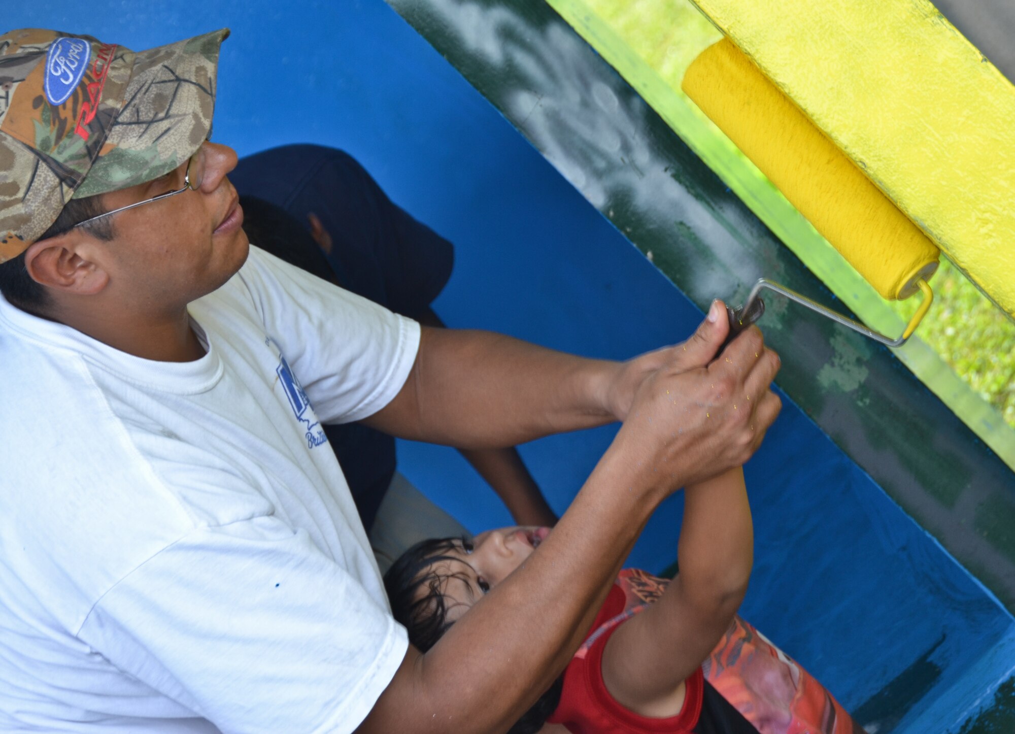 Airmen from the 36th Maintenance Squadron and 36th Wing chapel paint a bus stop for an Island Beautification project in Mangilao, Guam Oct 15.  Throughout the year, squadrons from Andersen AFB volunteer their time to help clean, repair and build areas in Guam communities in support of  the Islandwide Beautification Task Force. (U.S. Air Force photo by Staff Sgt. Alexandre Montes/RELEASED) 