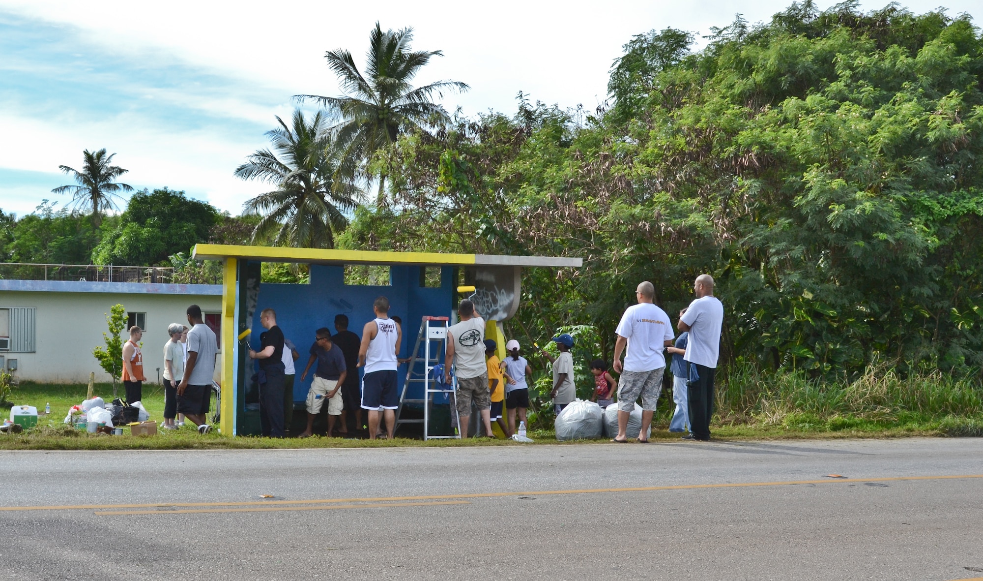 Airmen from the 36th Maintenance Squadron and 36th Wing chapel paint a bus stop for an Island Beautification project in Mangilao, Guam Oct 15.  Throughout the year, squadrons from Andersen AFB volunteer their time to help clean, repair and build areas in Guam communities in support of  the Islandwide Beautification Task Force. (U.S. Air Force photo by Staff Sgt. Alexandre Montes/RELEASED) 