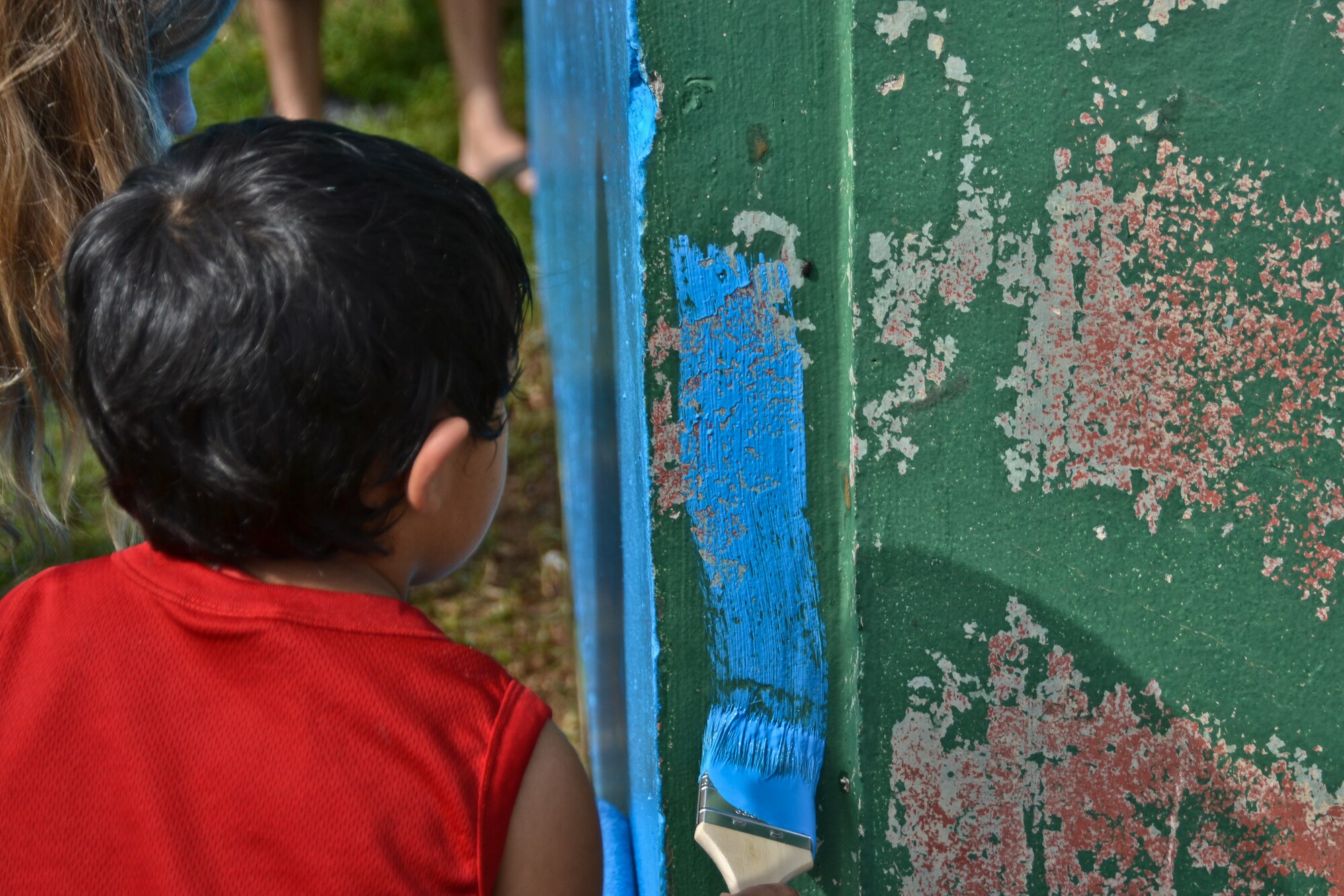 Airmen from the 36th Maintenance Squadron and 36th Wing chapel paint a bus stop for an Island Beautification project in Mangilao, Guam Oct 15.  Throughout the year, squadrons from Andersen AFB volunteer their time to help clean, repair and build areas in Guam communities in support of  the Islandwide Beautification Task Force. (U.S. Air Force photo by Staff Sgt. Alexandre Montes/RELEASED) 