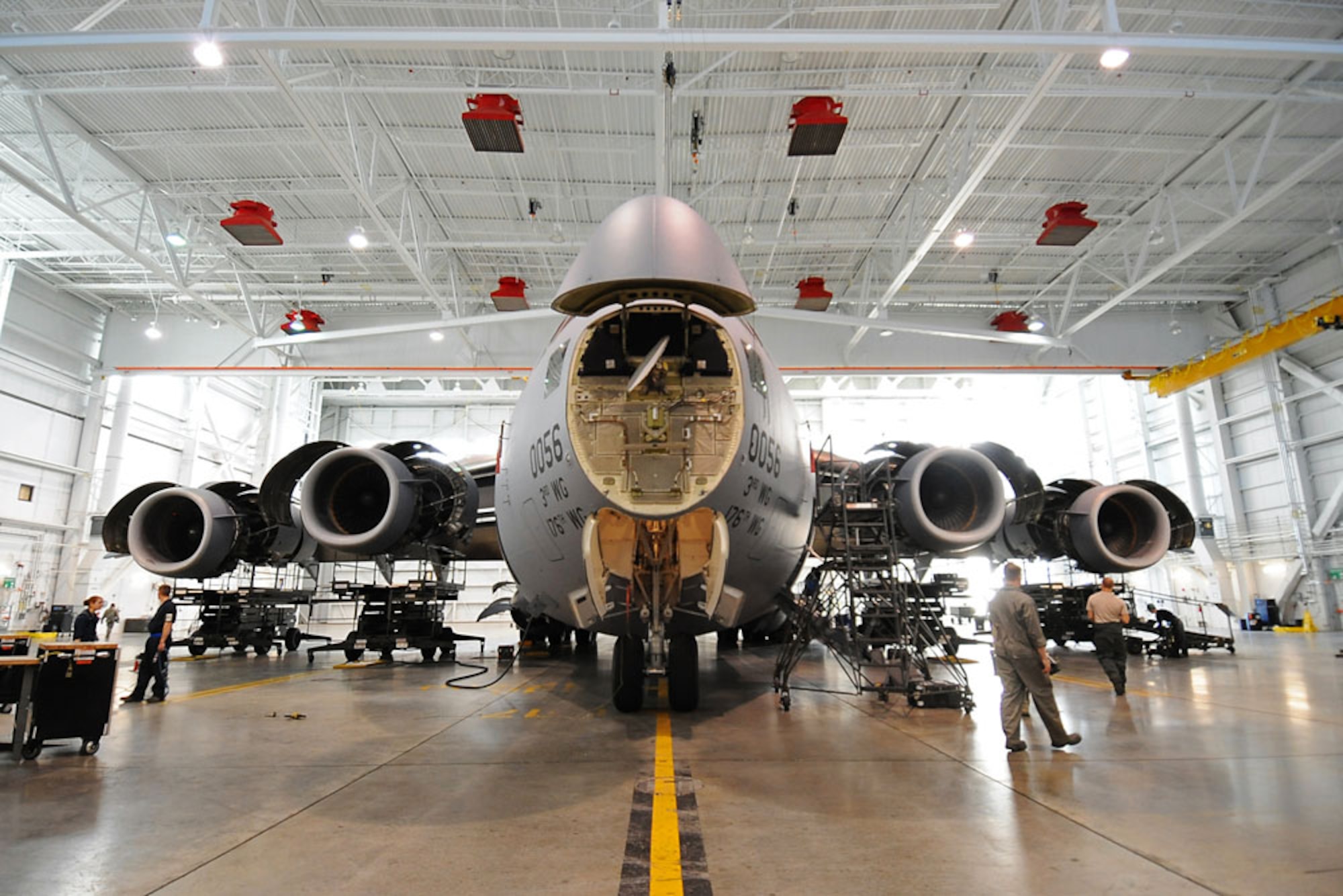 A C-17 Globemaster III, assigned to the 3rd Operations Group, 3rd Wing, sits inside a hangar with all accessory doors and thrust reversers open for a home station check, Oct. 11. The intense, four-day inspection of the C-17 checks the ins and outs of the aircraft, not a part of a normal everyday inspection. Maintainers from multiple career specialties with the 3rd Maintenance Squadron work together to complete the HSC process. (U.S. Air Force photo/Senior Airman Cynthia Spalding)