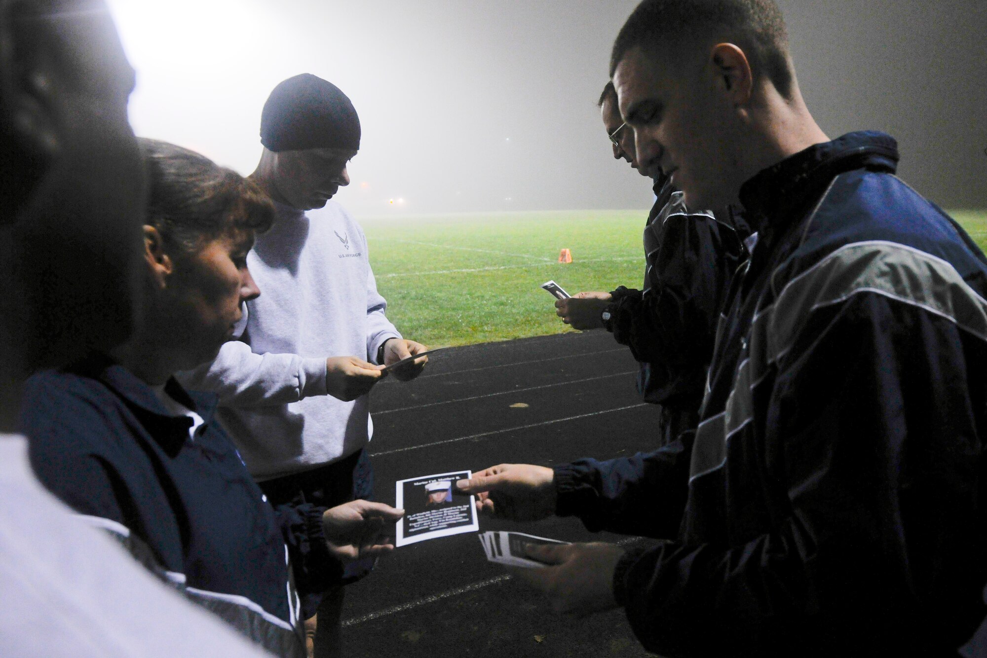 VANDENBERG AIR FORCE BASE, Calif. -- Base leadership receive cards containing a short biography of fallen servicemembers before the opening lap of the A Run to Remember event at the Vandenberg track Thursday, Oct. 20, 2011. The purpose of A Run to Remember is to honor all servicemembers who lost their lives in support of Operation Iraqi Freedom, Operation Enduring Freedom and Operation New Dawn. (U.S. Air Force Photo/Staff Sgt. Levi Riendeau)
