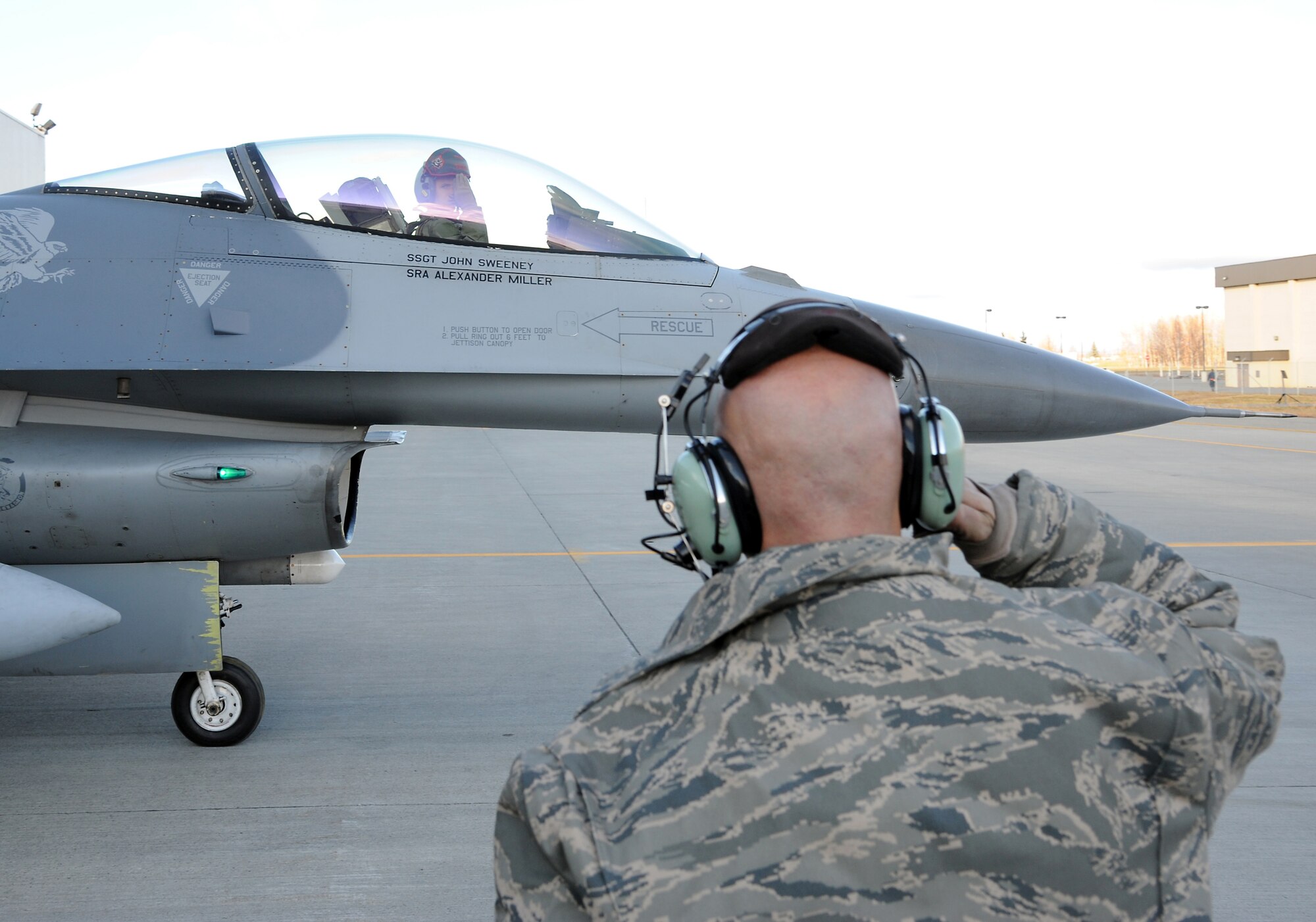 U.S. Air Force Captain Chris Behrens returns a salute from Senior Airman Matthew Smith Oct. 12, 2011, Eielson Air Force Base, Alaska. A salute is given to a pilot by a crew chief before every flight. Behrens is an F-16 Fighting Falcon pilot assigned to the 13th Fighter Squadron, Misawa Air Base, Japan. Smith is a crew chief assigned to the 35th Aircraft Maintenance Squadron, Misawa Air Base, Japan. (U.S. Air Force photo by Senior Airman Willard E. Grande II/Released)
