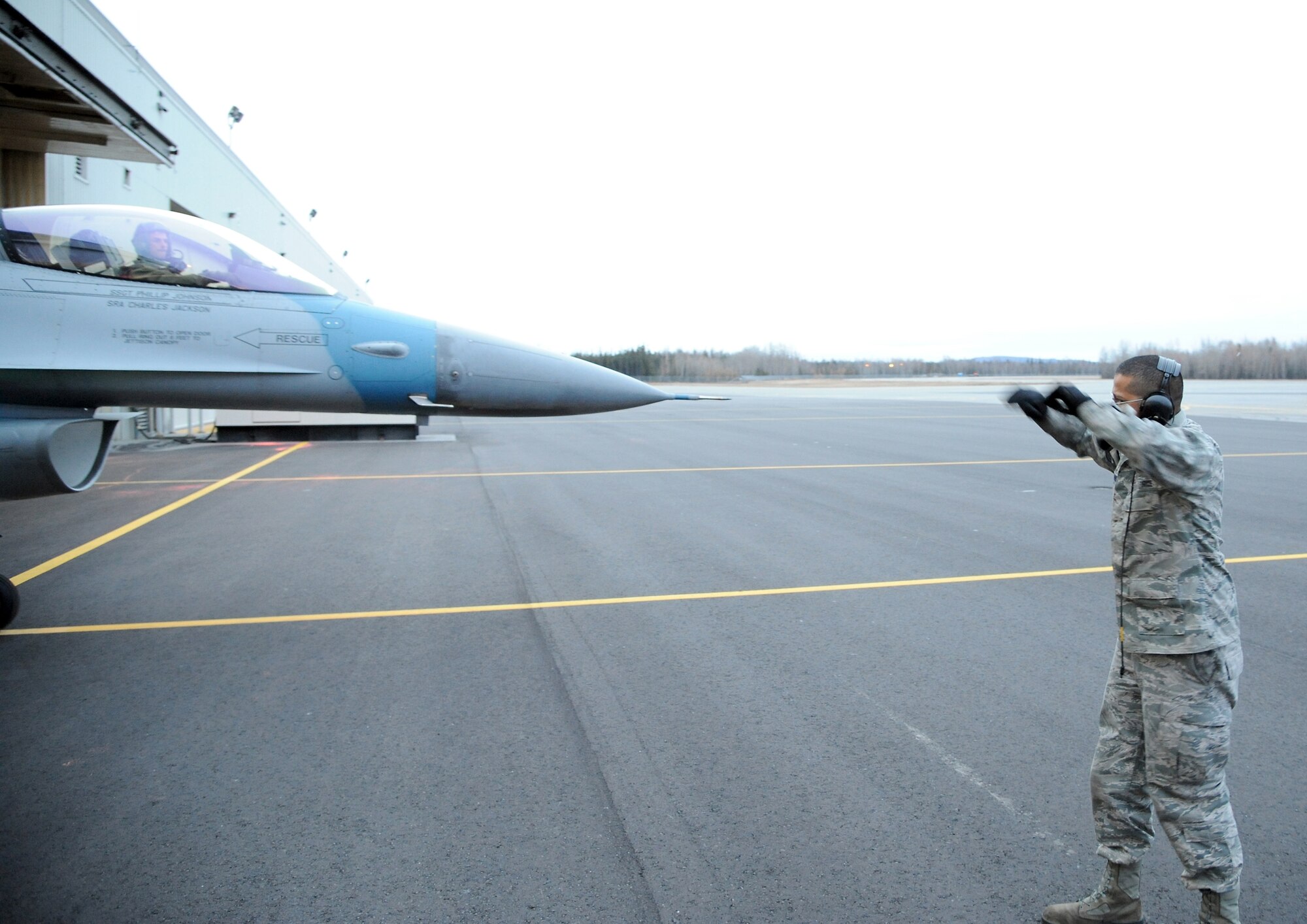 U.S. Air Force Airman 1st Class Lenford Johnston taxies a U.S. Air Force F-16 Fighting Falcon Oct. 12, 2011, Eielson Air Force Base, Alaska. During RED FLAG-Alaska crew chiefs, like Johnston, are an integral part of the mission tempo and help to ensure smooth flightline operation. Johnston is assigned to the 354th Aircraft Maintenance Squadron. (U.S. Air Force photo by Senior Airman Willard E. Grande II/Released)