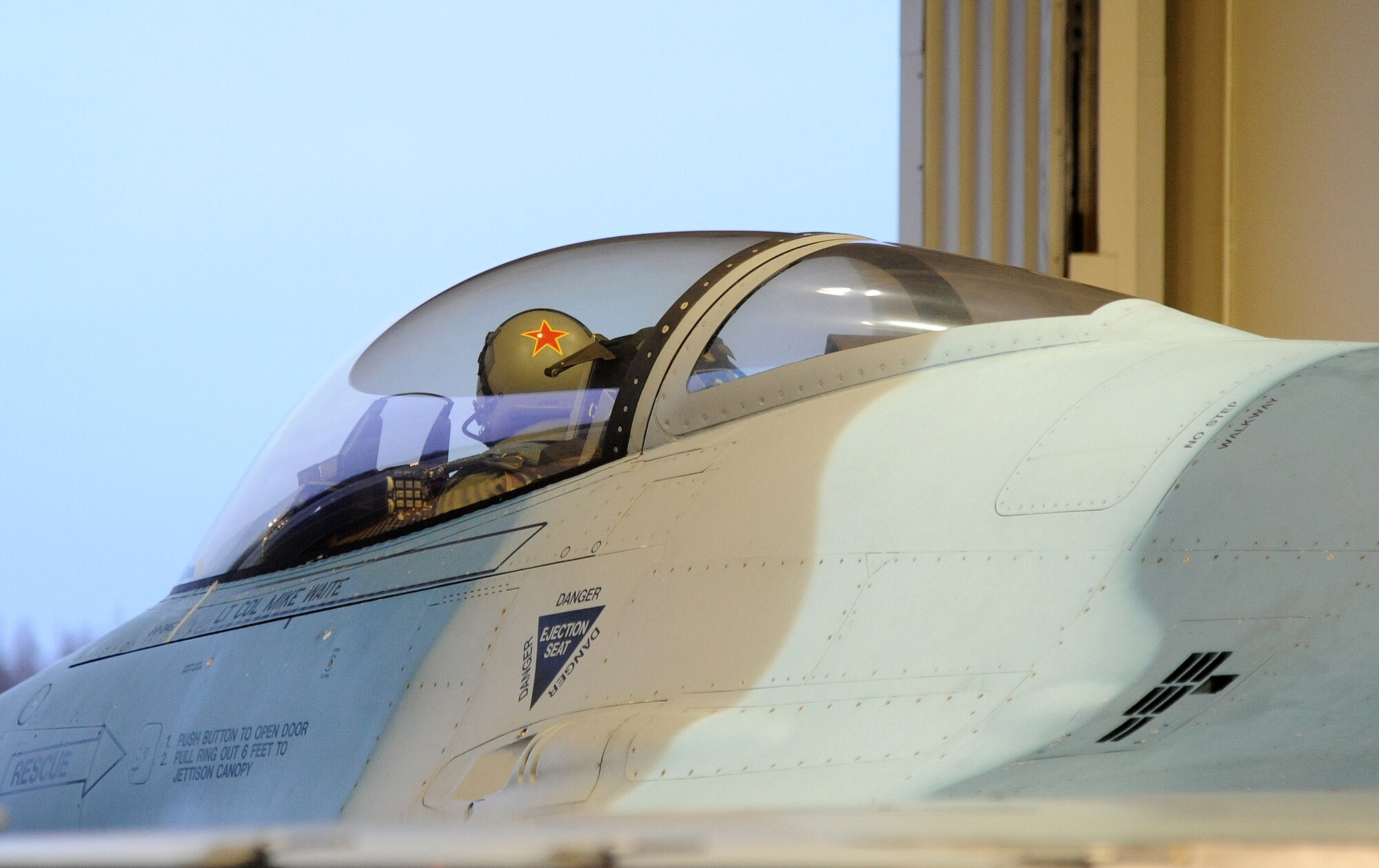 U.S. Air Force Captain Max Cover conducts preflight checks in an U.S. Air Force F-16 Fighting Falcon Oct. 12, 2011, Eielson Air Force Base, Alaska. Cover is participating in RED FLAG-Alaska, where he plays the role as a hostile aircraft providing training opportunities to visiting units. Cover is an F-16 Fighting Falcon pilot assigned to the 18th Aggressor Squadron. (U.S. Air Force photo by Senior Airman Willard E. Grande II/Released)