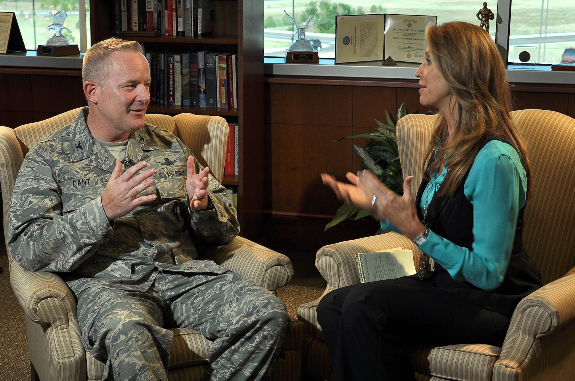 BUCKLEY AIR FORCE BASE, Colo.— U.S. Air Force Col. Daniel Dant, 460th Space Wing commander, talks with Jacquie Palisi, a reporter from Channel 8 in Aurora, Colo. Oct. 14, 2011. Palisi interviewed Dant for a news story that discussed his experiences and how he felt about his position as the Wing Commander. (U.S. Air Force photo by: Master Sgt. Jeromy K. Cross)