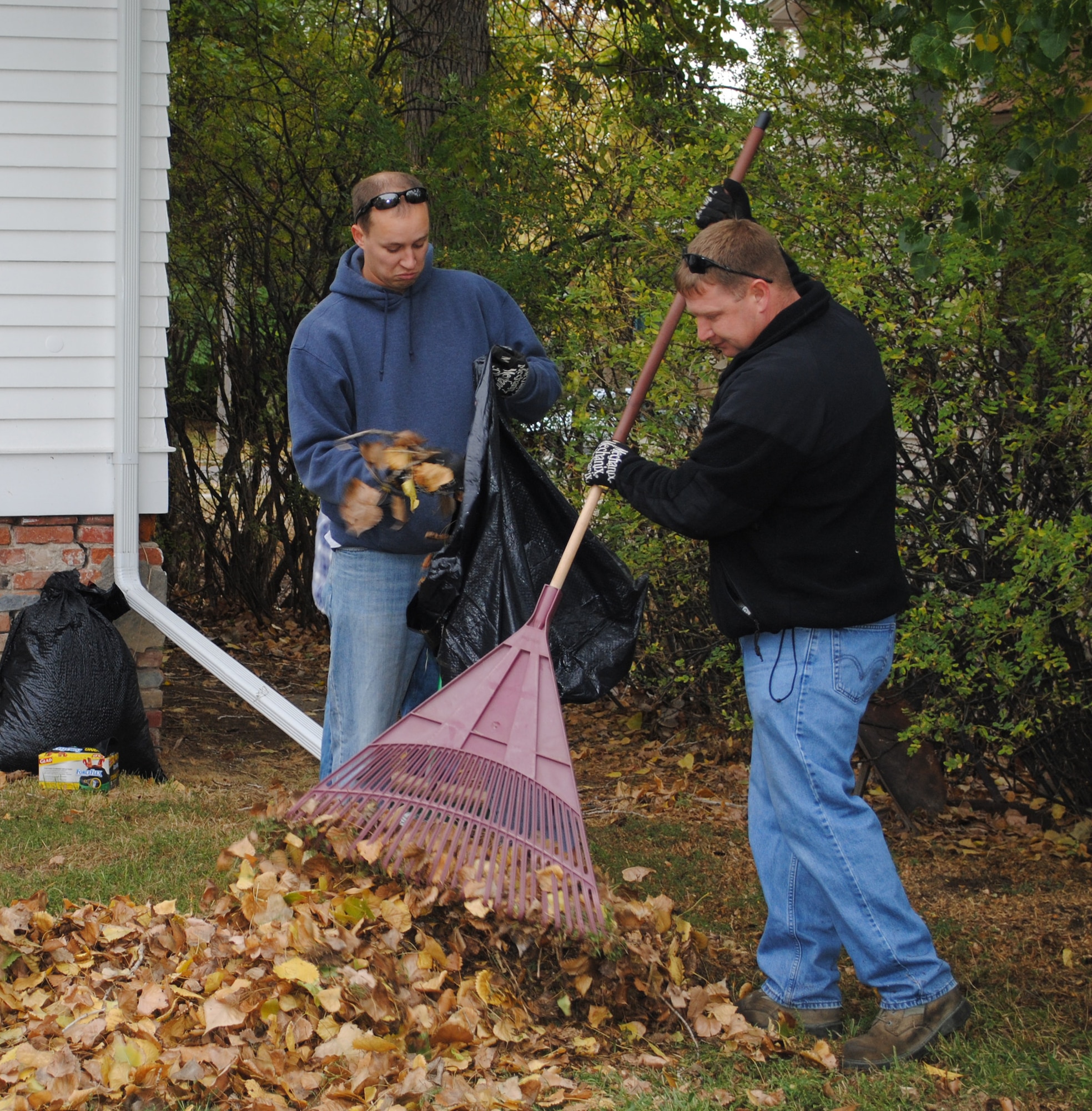 Capt. Nicki Saccone, 819th RED HORSE Squadron project manager, bags leaves while Tech. Sgt. Shane Anderson, 819th RHS special purpose mechanic, rakes them into a pile.  More than 250 people showed up to participate in the 2011 Day of Caring Oct. 14.  (U.S. Air Force photo/Airman Cortney Paxton) 