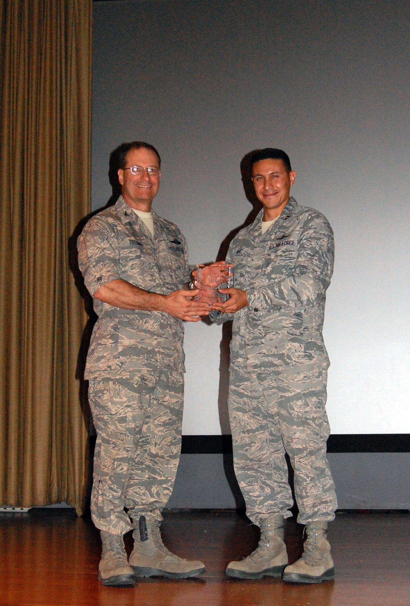 NELLIS AIR FORCE BASE, Nev. -- (Right) Capt. Fernando Ruiz, 706th Fighter Squadron cyber operations director, is awarded as the 926th Group's company grade officer of the half by Col. Herman Brunke, 926th GP commander, here Oct. 15. 