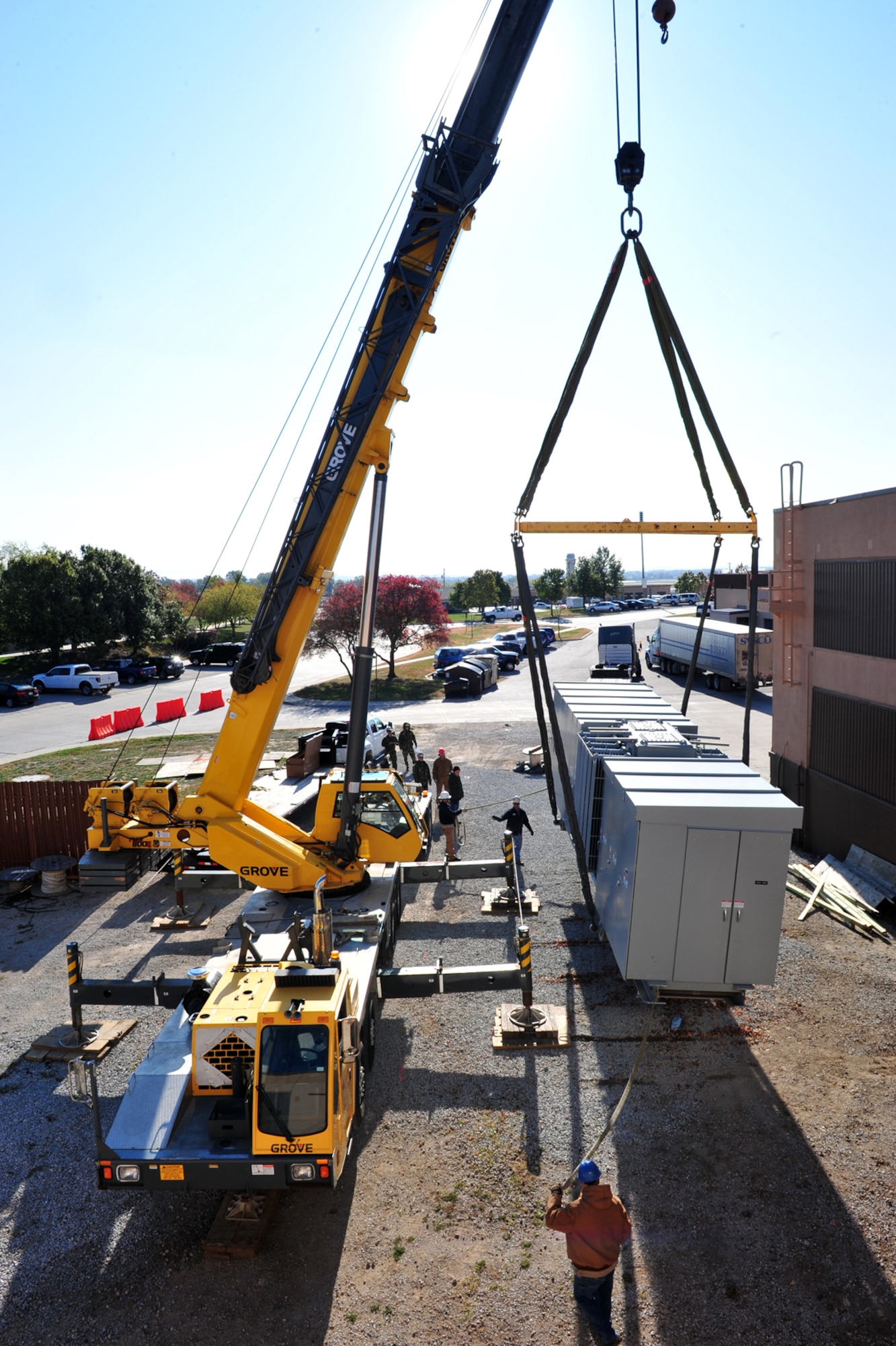A crane loads a 60,000 pound, 3.2 megawatt power plant and 5,000 KVA substation onto a flatbed truck for its return trip to the Naval Facilities Expeditionary Logistics Center in Port Hueneme, Calif. The equipment was delivered to Offutt Air Force Base, Neb., by a Mobile Utilities Support Equipment team back in July to provide temporary support to the Air Force Weather Agency headquarters facility here. At that time the Missouri River was threatening to flood the base, so the temporary portable electrical power would have been used to decrease the load on the base's generator plant and ensure AFWA's electrical power would have continued. (Air Force photo by Charles Haymond)