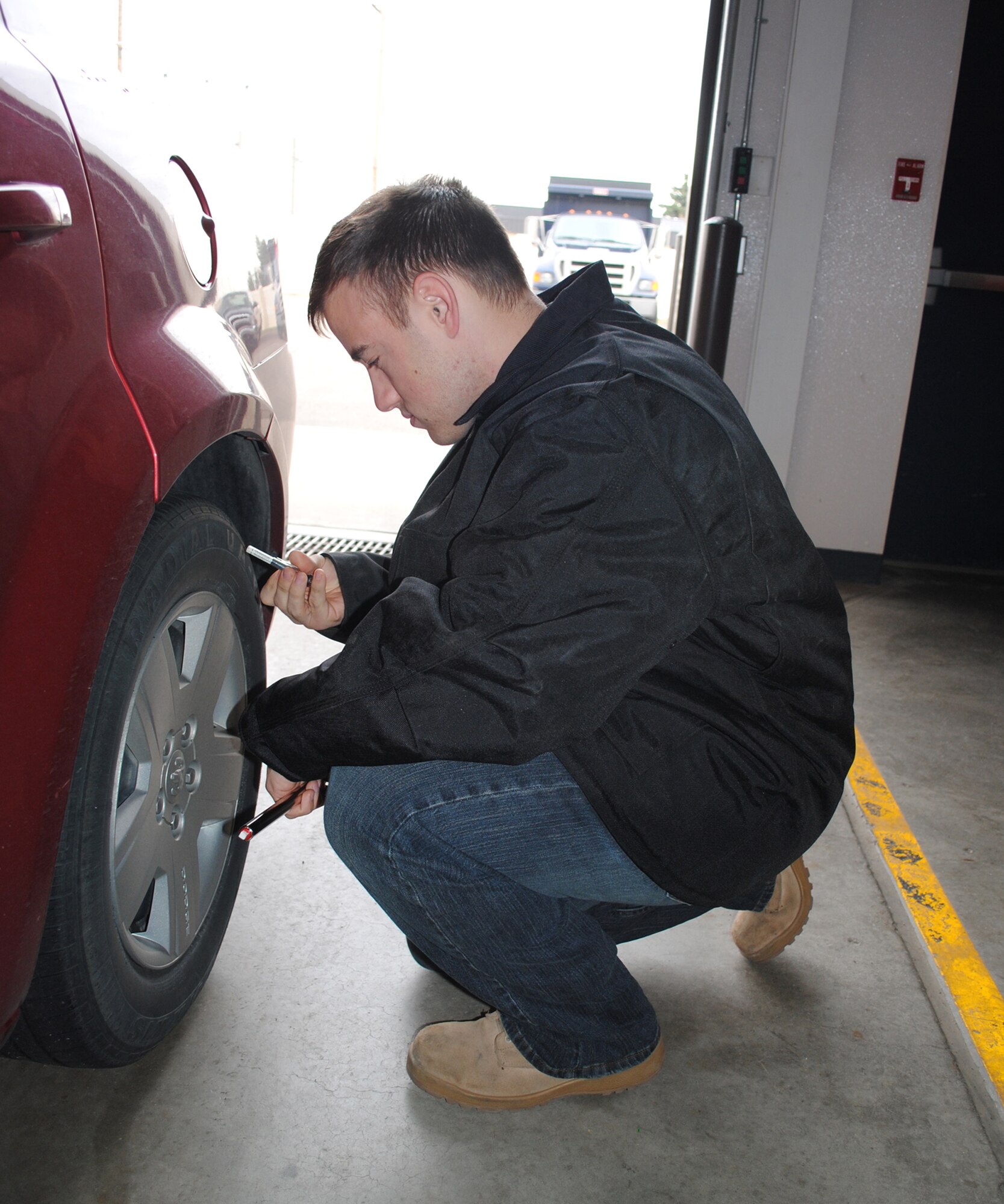 Airman 1st Class Michael Brinkofski, vehicle and equipment apprentice with the 341st LRS, checks the tire pressure during a privately owned vehicle inspection held at Bldg. 870 Oct. 16.  (U.S. Air Force photo/Airman 1st Class Katrina Heikkinen)