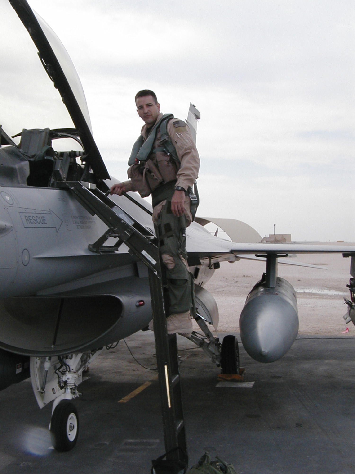 Lt. Col. Glen Messner, 115th Fighter Wing pilot, ascends into a F-16 Falcon at an air base in Southwest Asia in 2004. Photo courtesy
