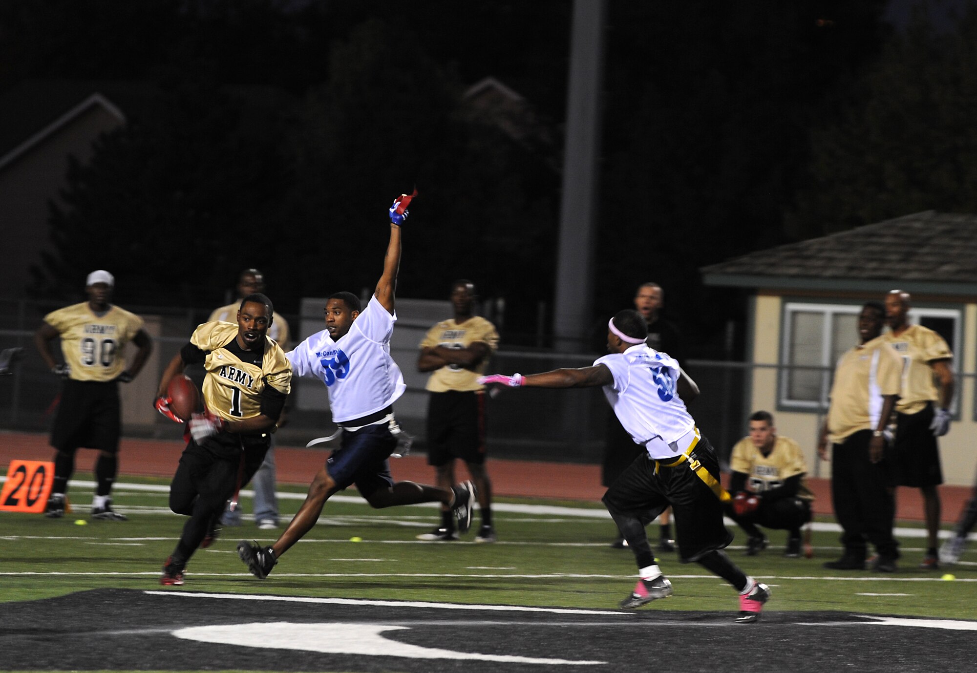 Steffon Jackson, McConnell Team strong safety, steals Brett Brown’s flag, Fort Riley team defensive lineman, ending the play and preventing the Soldiers from gaining yards during the annual flag football game at Panther Field, Oct. 15, 2011, Derby, Kan.  The Tornadoes came back in the fourth quarter to win 20-18.  (U.S. Air Force photo by Airman 1st Class Jose L. Leon