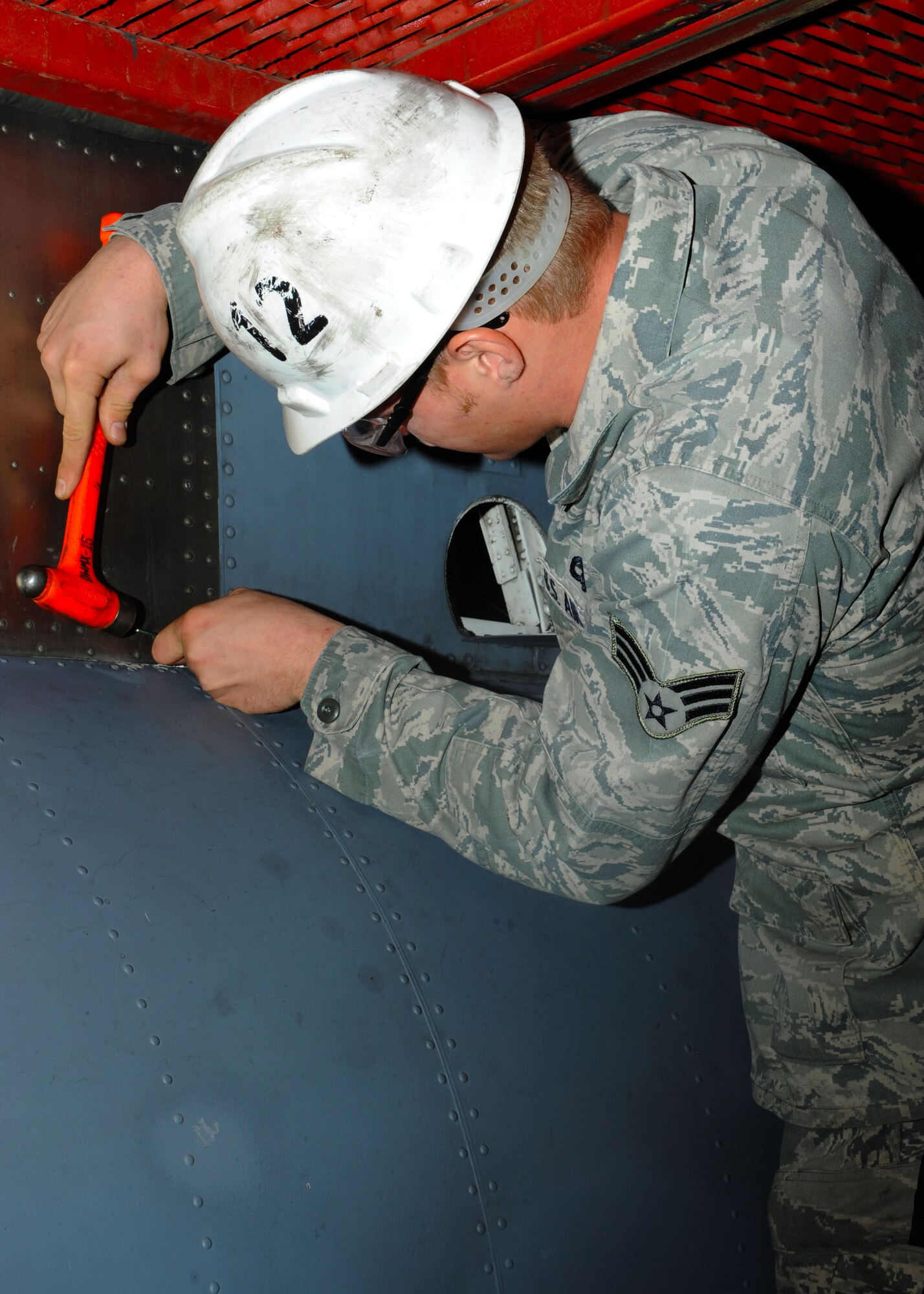 Airman 1st Class Eric Lopez and Airman 1st Class Marcos Morales from the 317th Maintenance Squadron clear debris and check for cracks on a C-130 Hercules during an inspection Oct. 20, 2011 at Dyess Air Force Base, Texas. Inspections are conducted yearly on C-130s ensuring mission readiness. (U.S. Air Force photo by Airman 1st Class Jonathan Stefanko/ Released)