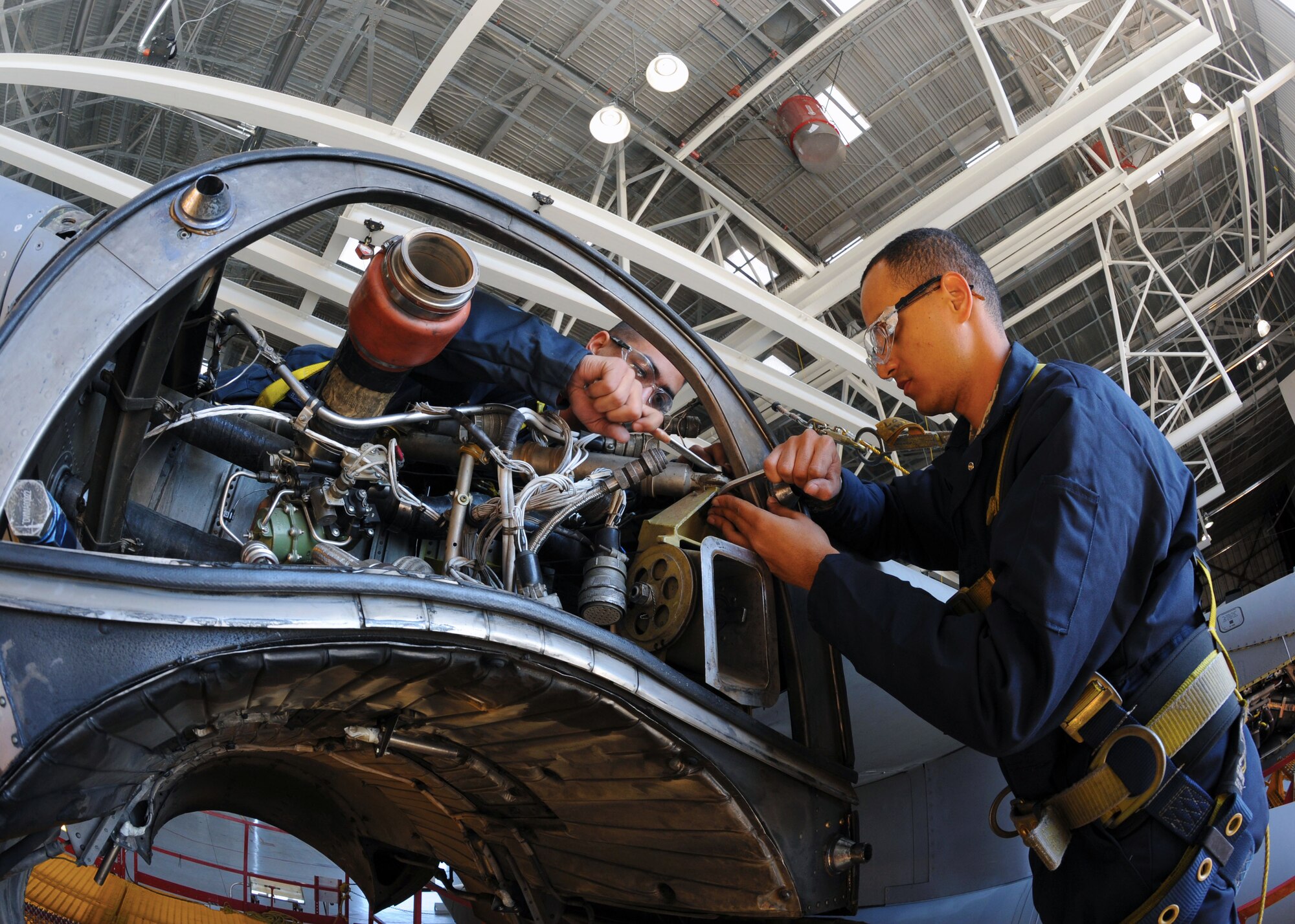 Airman 1st Class Eric Lopez and Airman 1st Class Marcos Morales from the 317th Maintenance Squadron clear debris and check for cracks on a C-130 Hercules during an inspection Oct. 20, 2011 at Dyess Air Force Base, Texas. Inspections are conducted yearly on C-130s ensuring mission readiness. (U.S. Air Force photo by Airman 1st Class Jonathan Stefanko/ Released)
